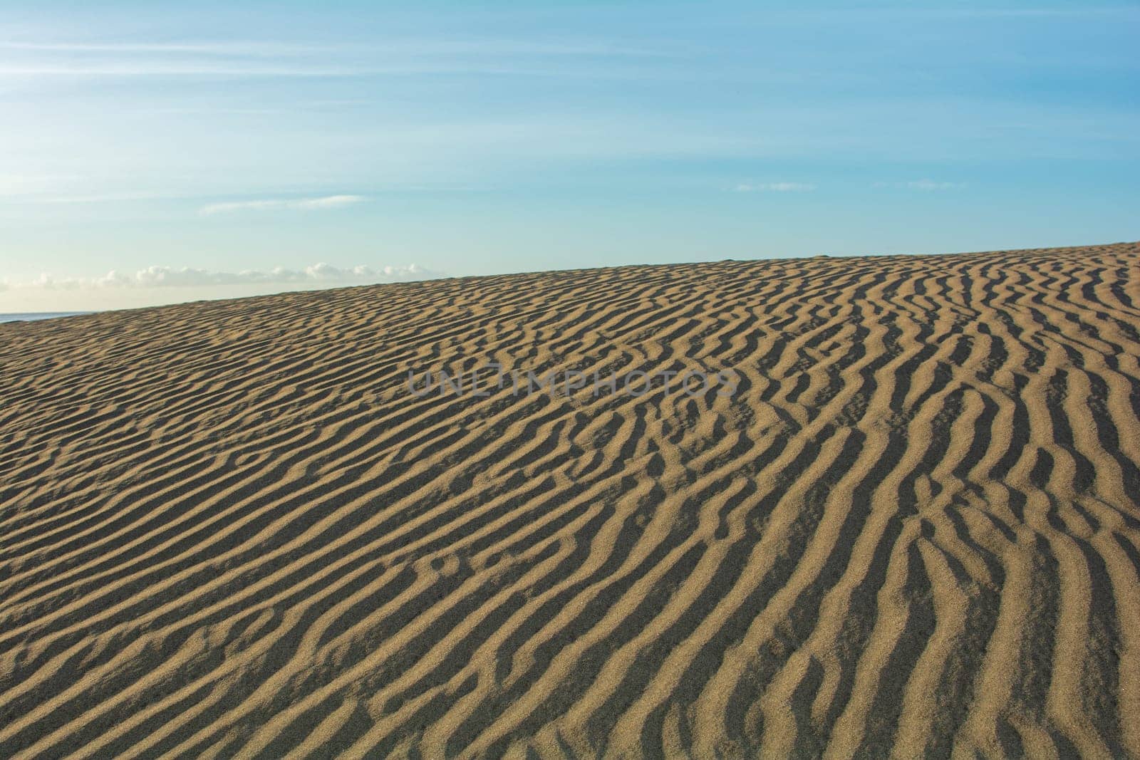 Lines in the desert sand with blue sky