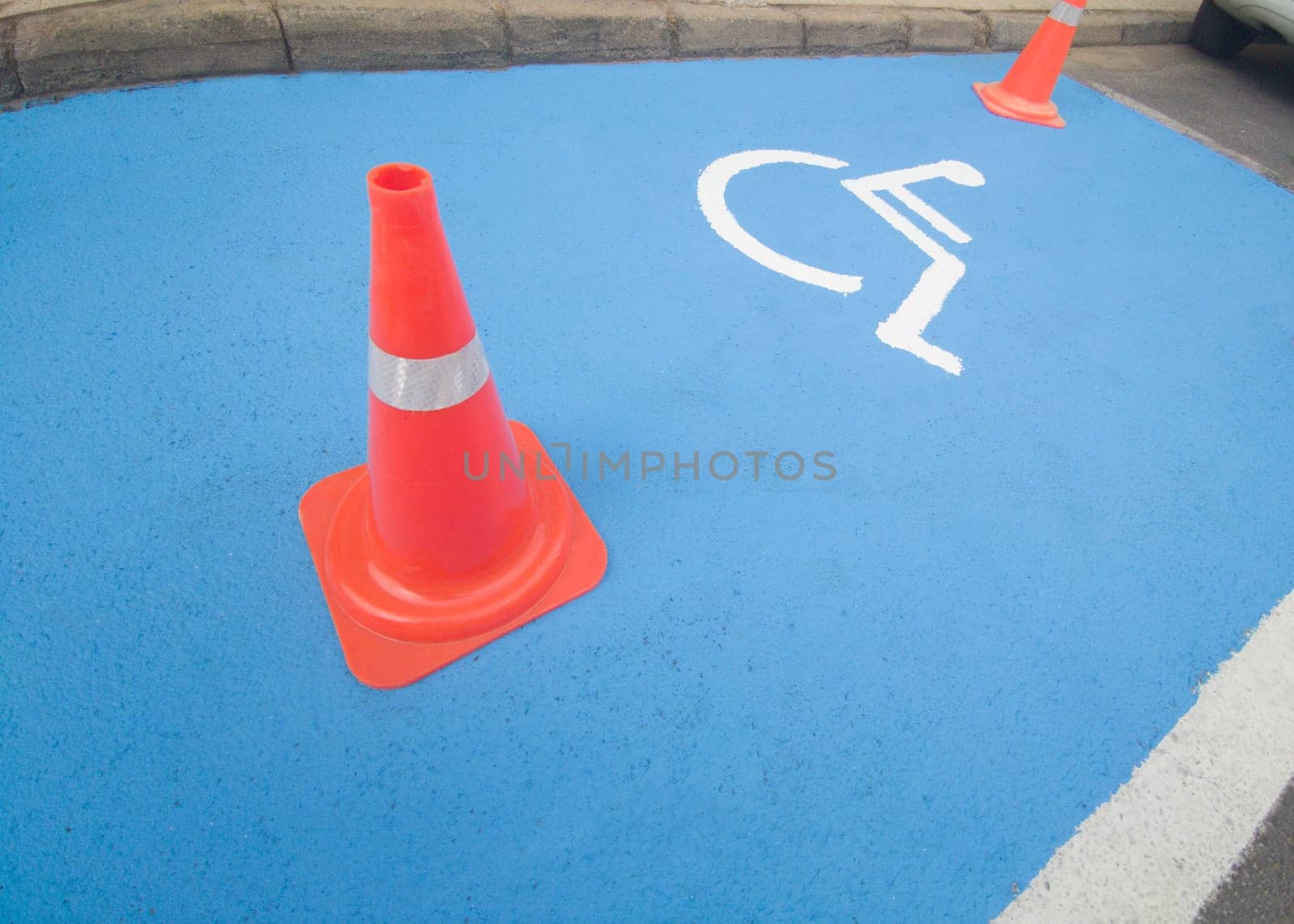Reserved parking for vehicles of people with disabilities. Just painted floor signal