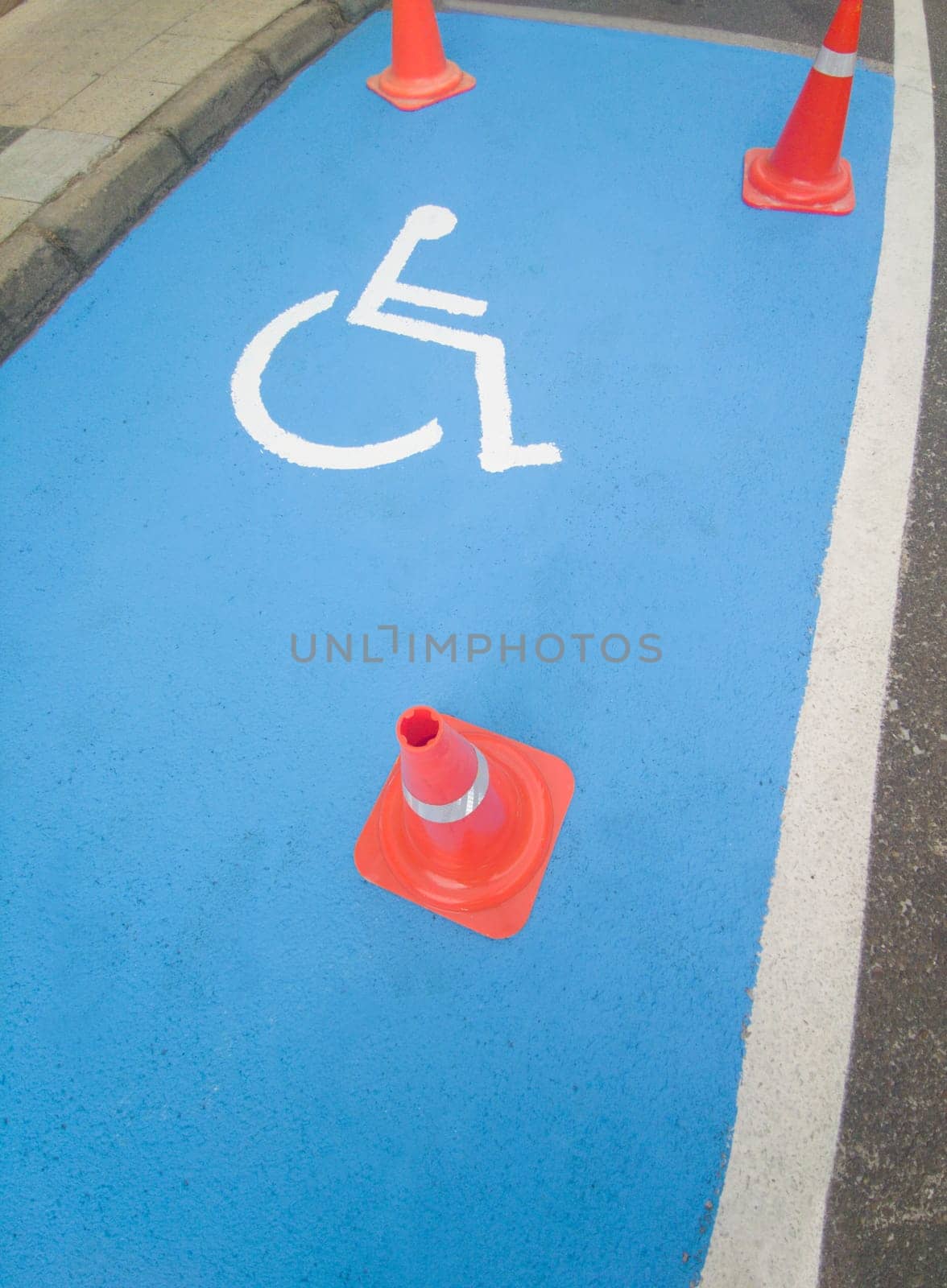 Reserved parking for vehicles of people with disabilities. Just painted floor signal