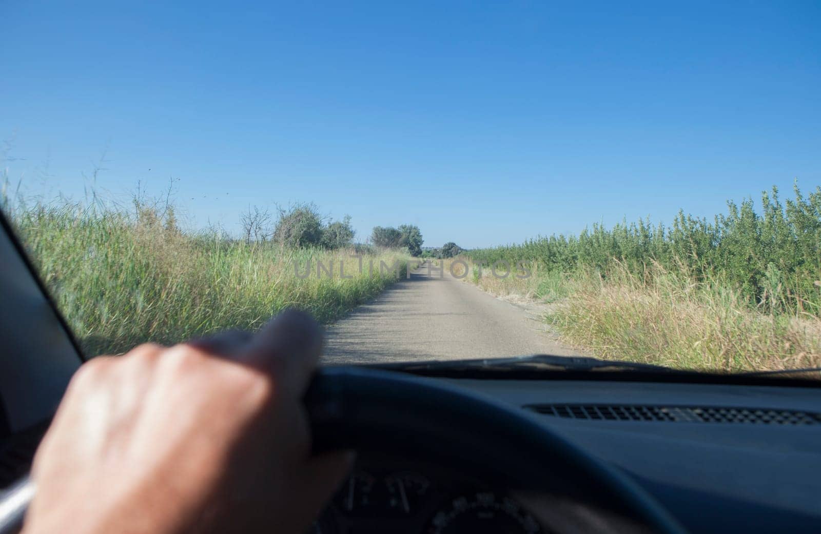 Driving on a narrow local road in Vegas Altas del Guadiana. View from the inside of the car