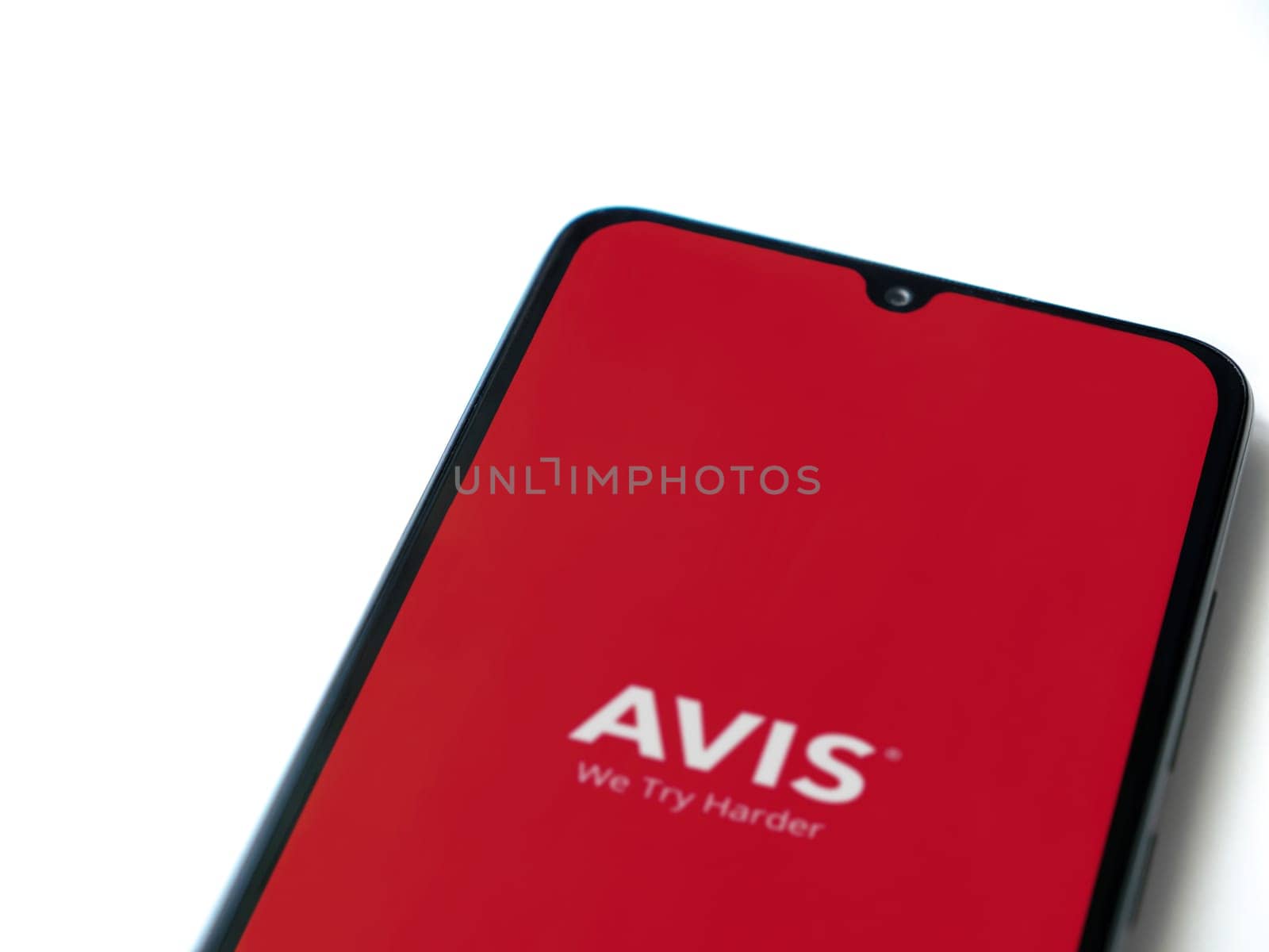 Lod, Israel - July 16,2023: Avis IL app launch screen on smartphone on white background. Top view flat lay with copy space.