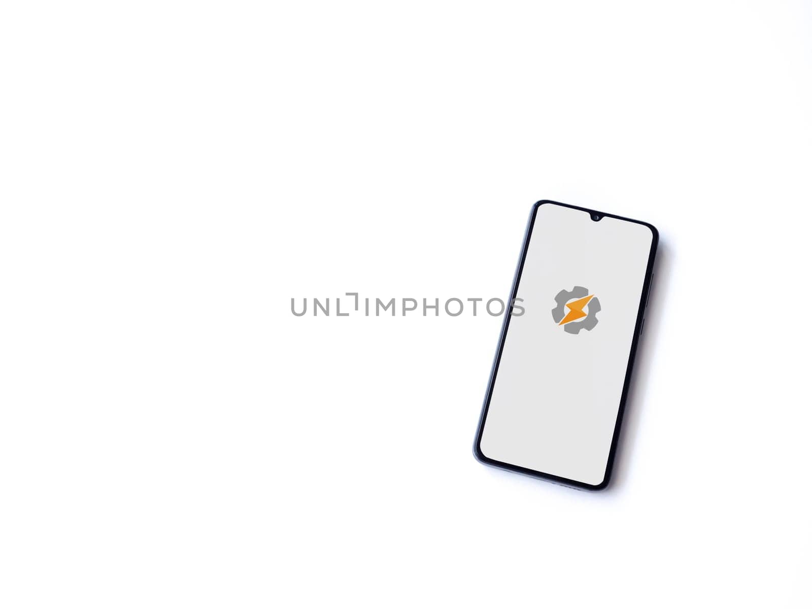 Lod, Israel - July 16,2023: Tasker app launch screen on smartphone on white background. Top view flat lay with copy space.