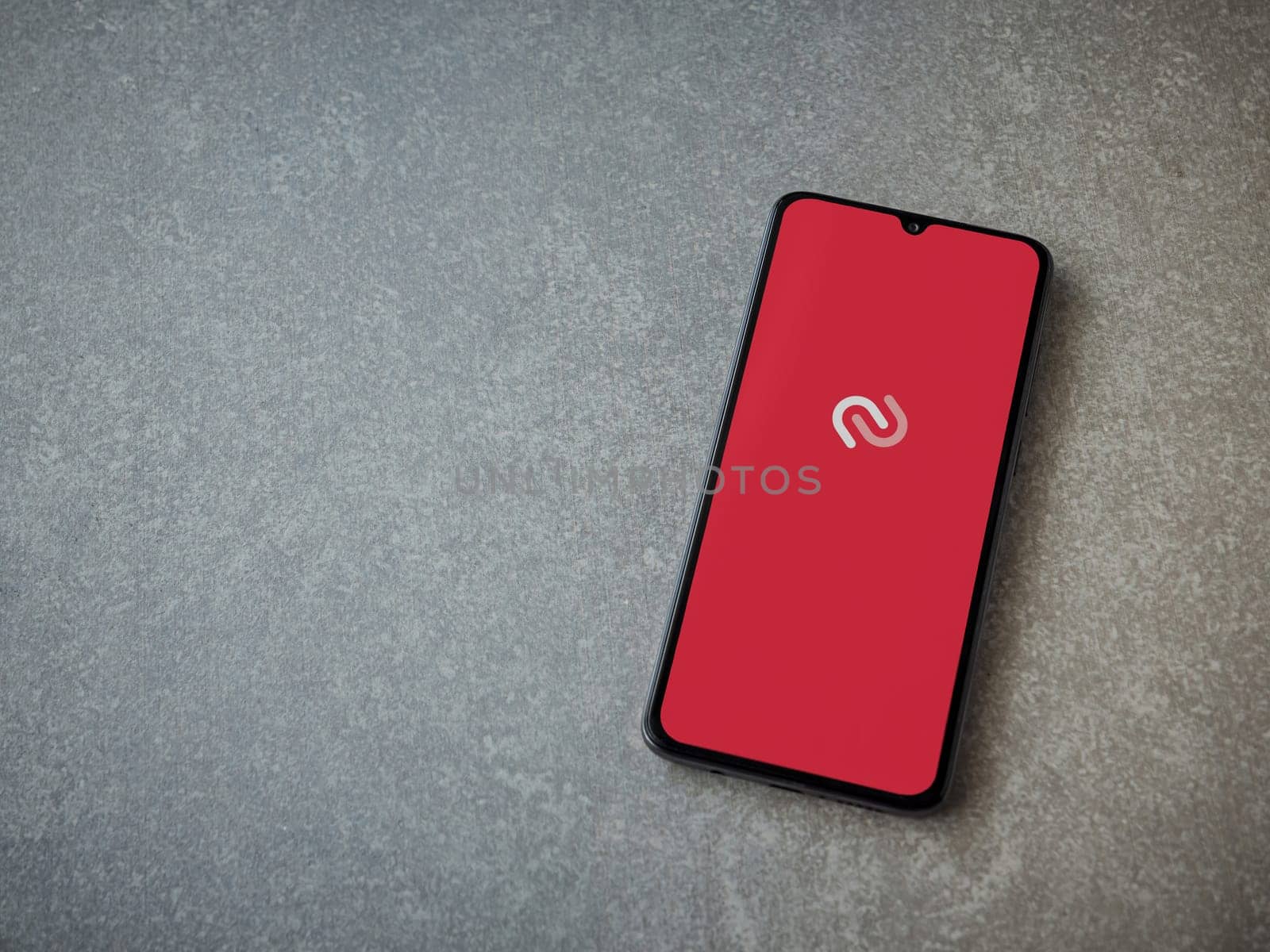 Lod, Israel - July 16,2023: Twilio Authy Authenticator app launch screen on smartphone on ceramic stone background. Top view flat lay with copy space.