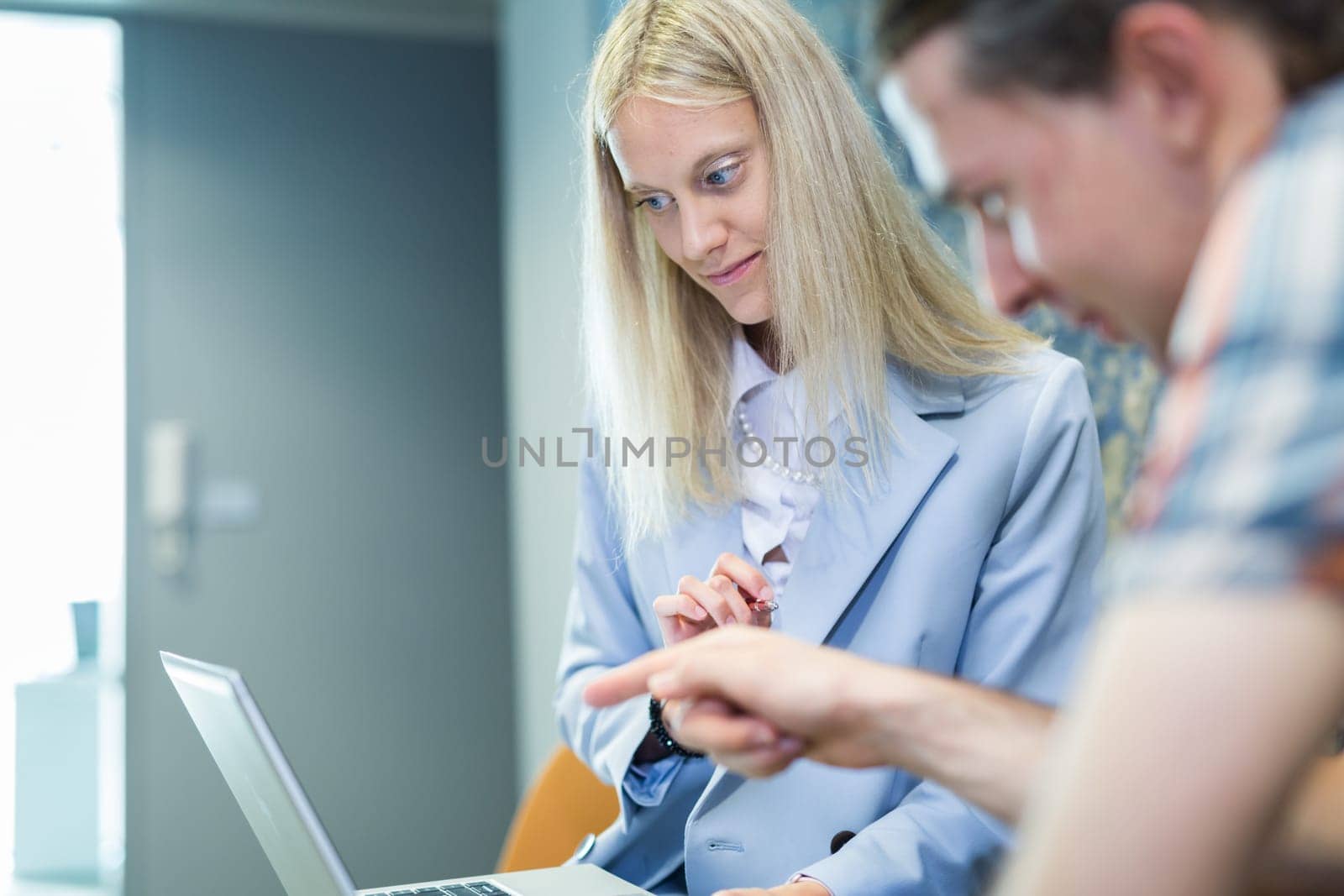 Business meeting. Client consulting. Confident business woman, real estate agent, financial advisor explaining details of project or financial product to client in office