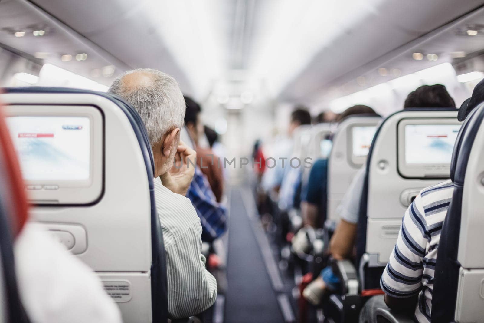 Interior of airplane with passengers on seats waiting to taik off.