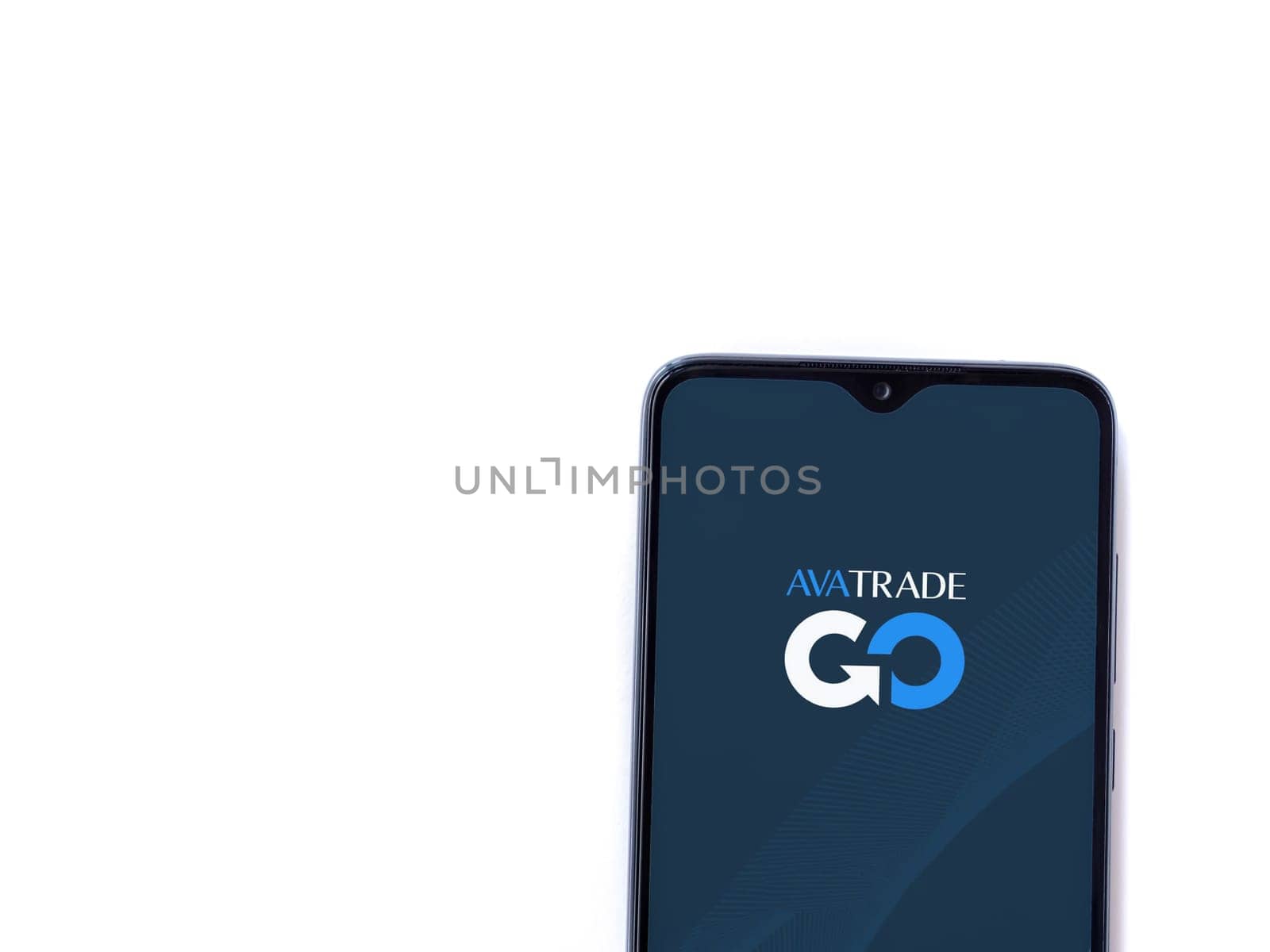 Lod, Israel - July 16,2023: Avatrade app launch screen on smartphone on white background. Top view flat lay with copy space.