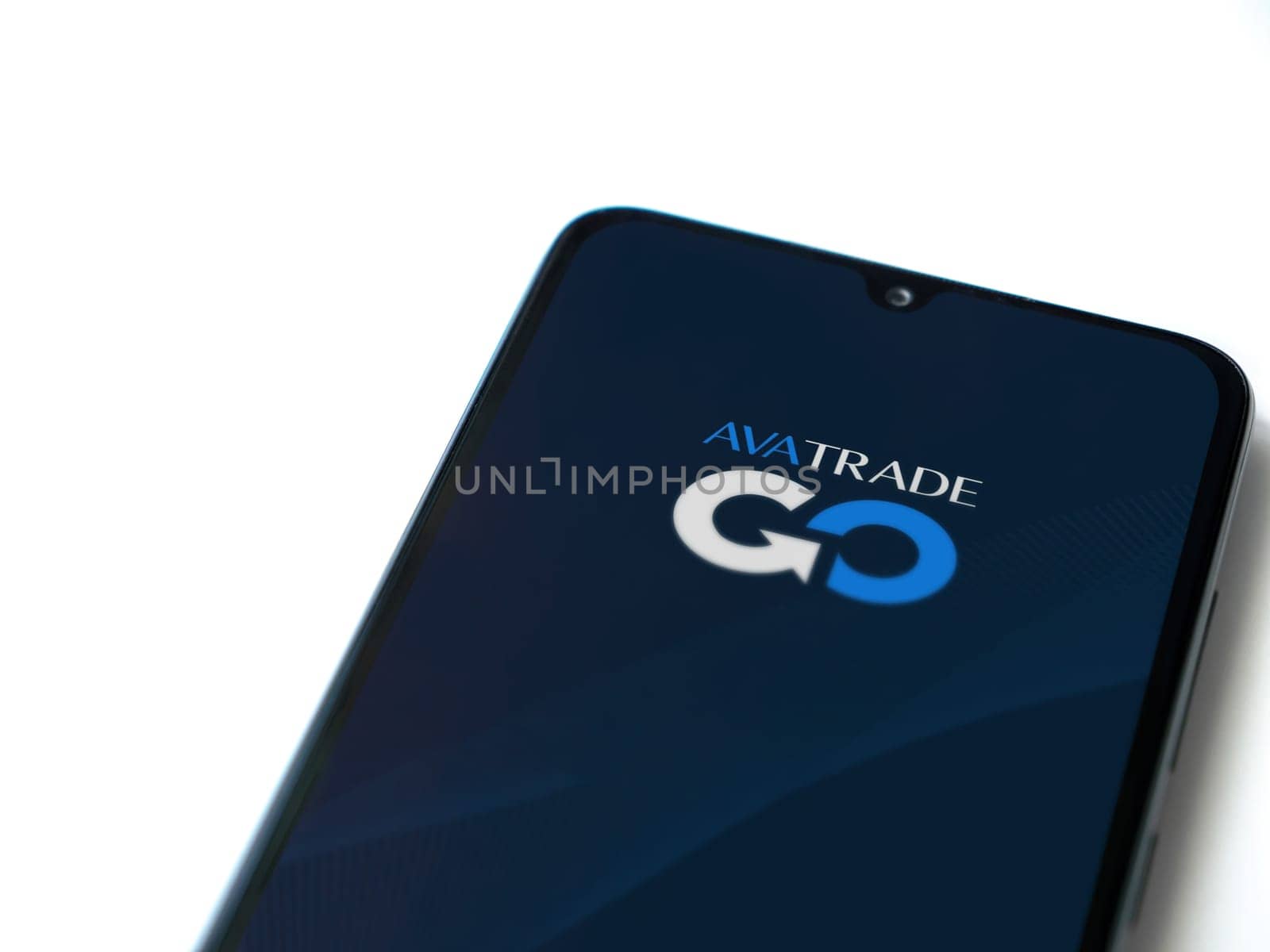 Lod, Israel - July 16,2023: Avatrade app launch screen on smartphone on white background. Top view flat lay with copy space.