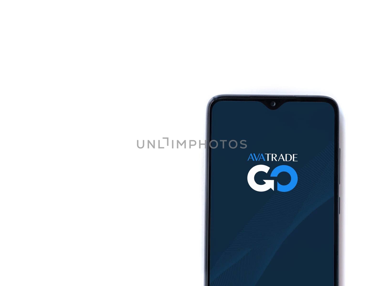 Lod, Israel - July 16,2023: Avatrade app launch screen on smartphone on white background. Top view flat lay with copy space.