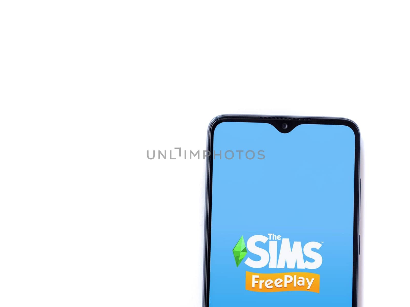 Lod, Israel - July 16,2023: The Sims FreePlay app launch screen on smartphone on white background. Top view flat lay with copy space.