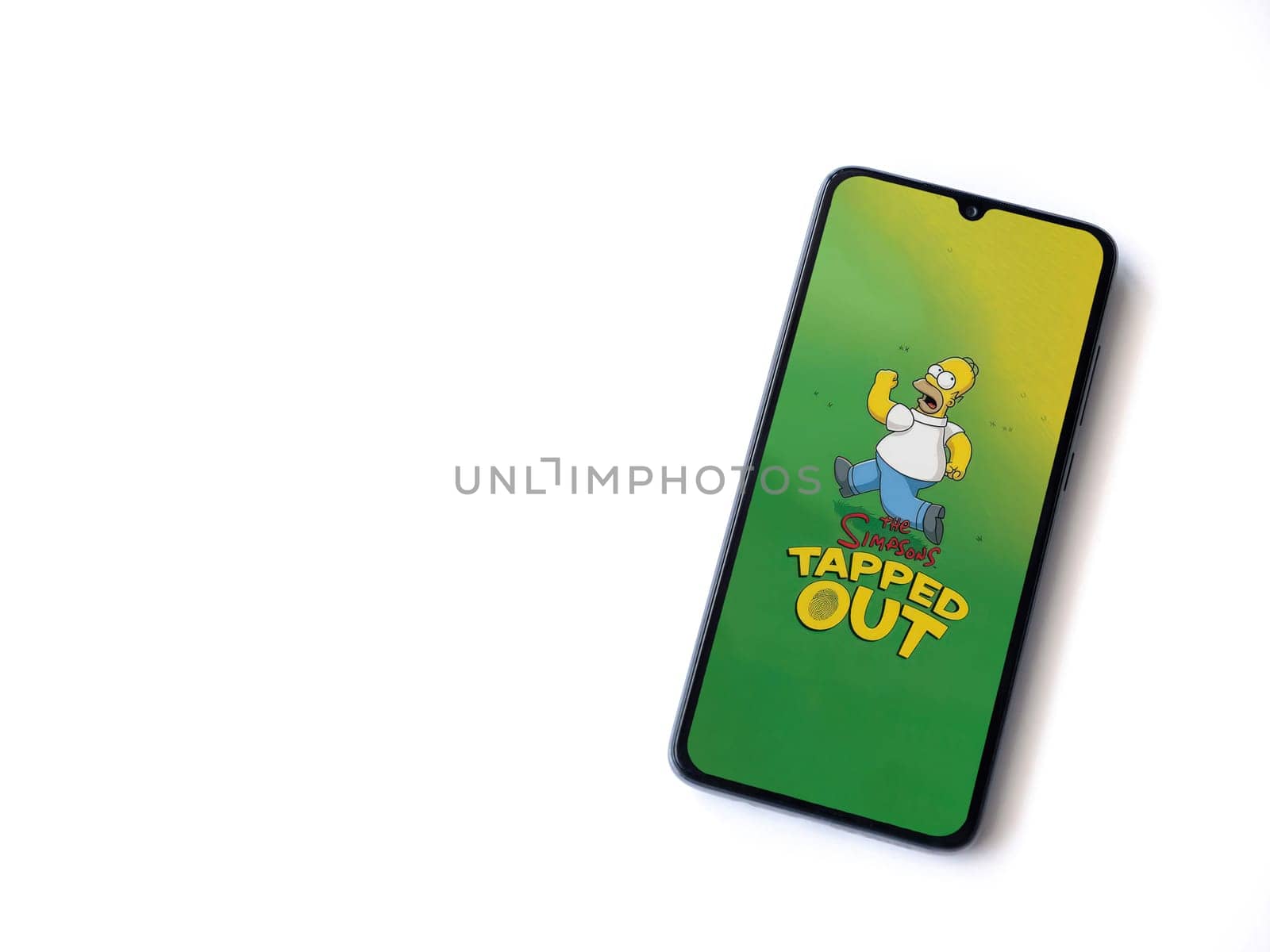Lod, Israel - July 16,2023: The Simpsons Tapped Out app launch screen on smartphone on white background. Top view flat lay with copy space.