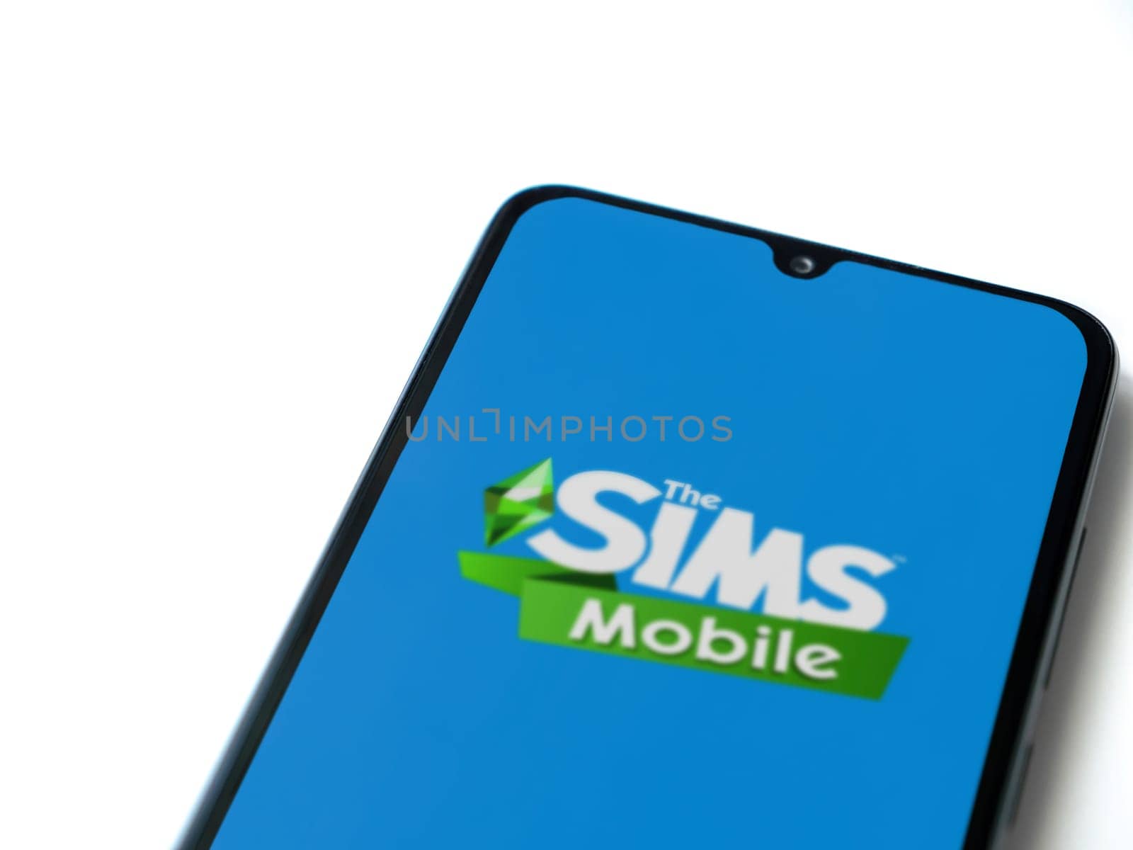 Lod, Israel - July 16,2023: The Sims Mobile app launch screen on smartphone on white background. Top view flat lay with copy space.