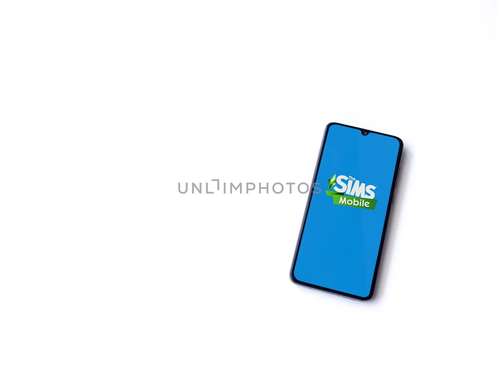 Lod, Israel - July 16,2023: The Sims Mobile app launch screen on smartphone on white background. Top view flat lay with copy space.
