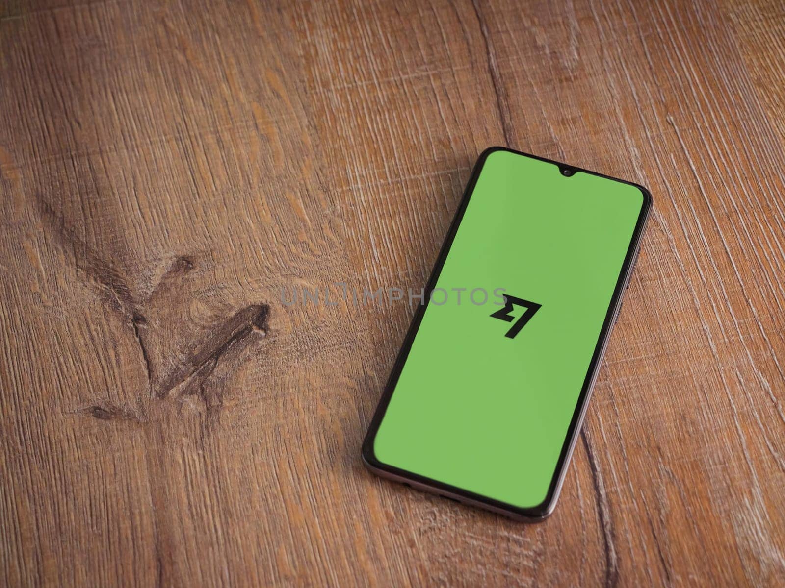 Lod, Israel - July 16,2023: Wise app launch screen on smartphone on wooden background. Top view flat lay with copy space.