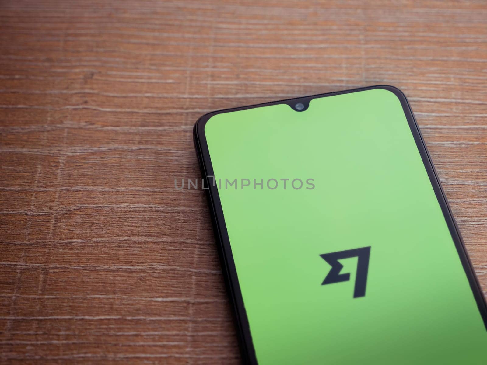 Lod, Israel - July 16,2023: Wise app launch screen on smartphone on wooden background. Top view flat lay with copy space.