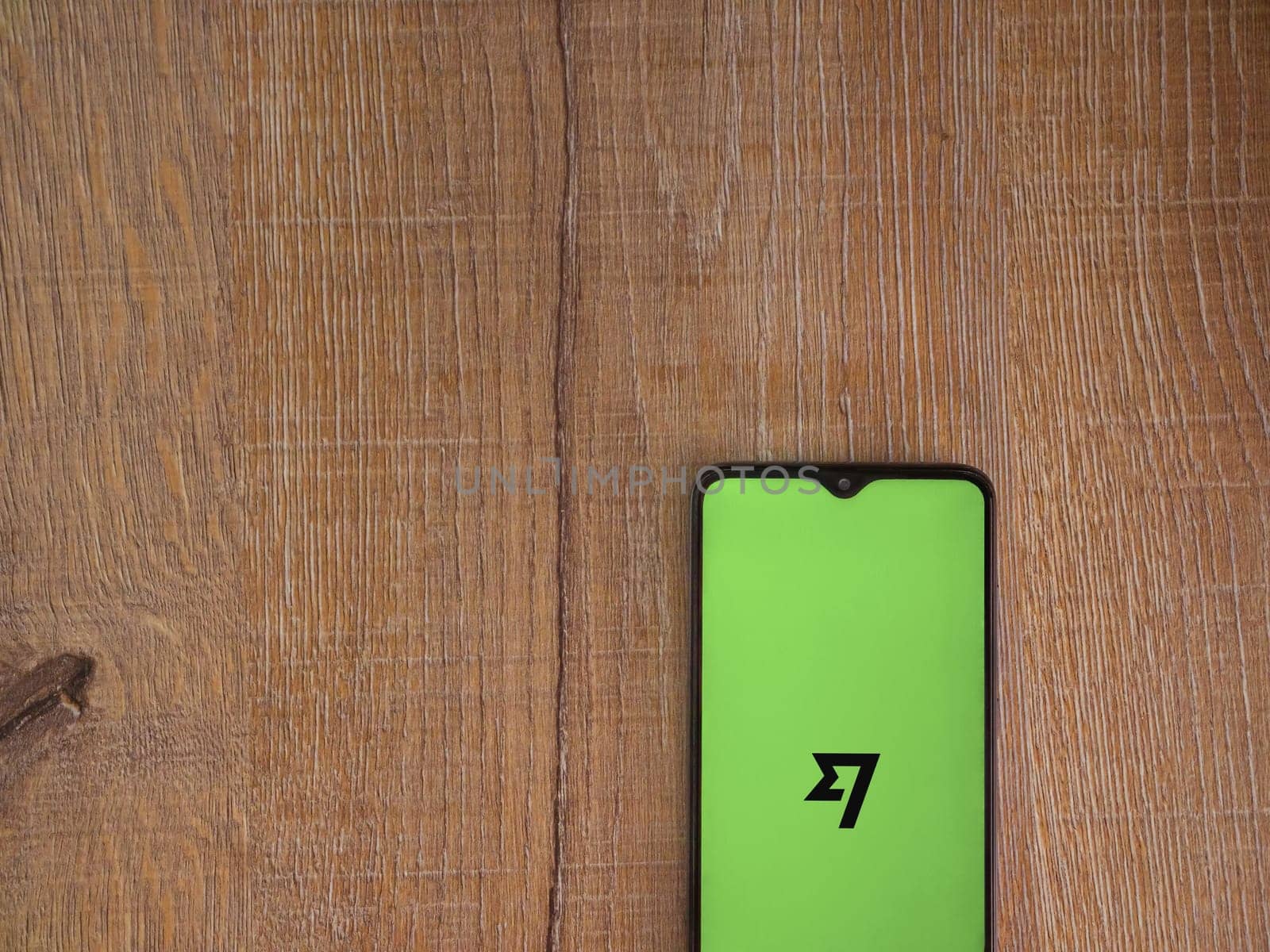 Lod, Israel - July 16,2023: Wise app launch screen on smartphone on wooden background. Top view flat lay with copy space.