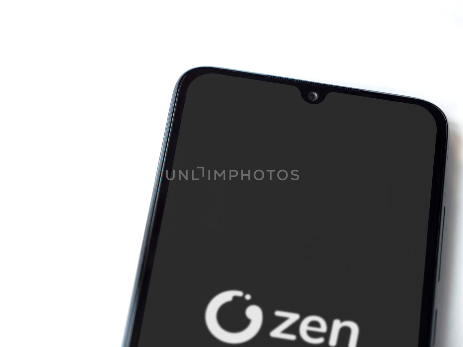 Lod, Israel - July 16,2023: ZEN.COM app launch screen on smartphone on white background. Top view flat lay with copy space.