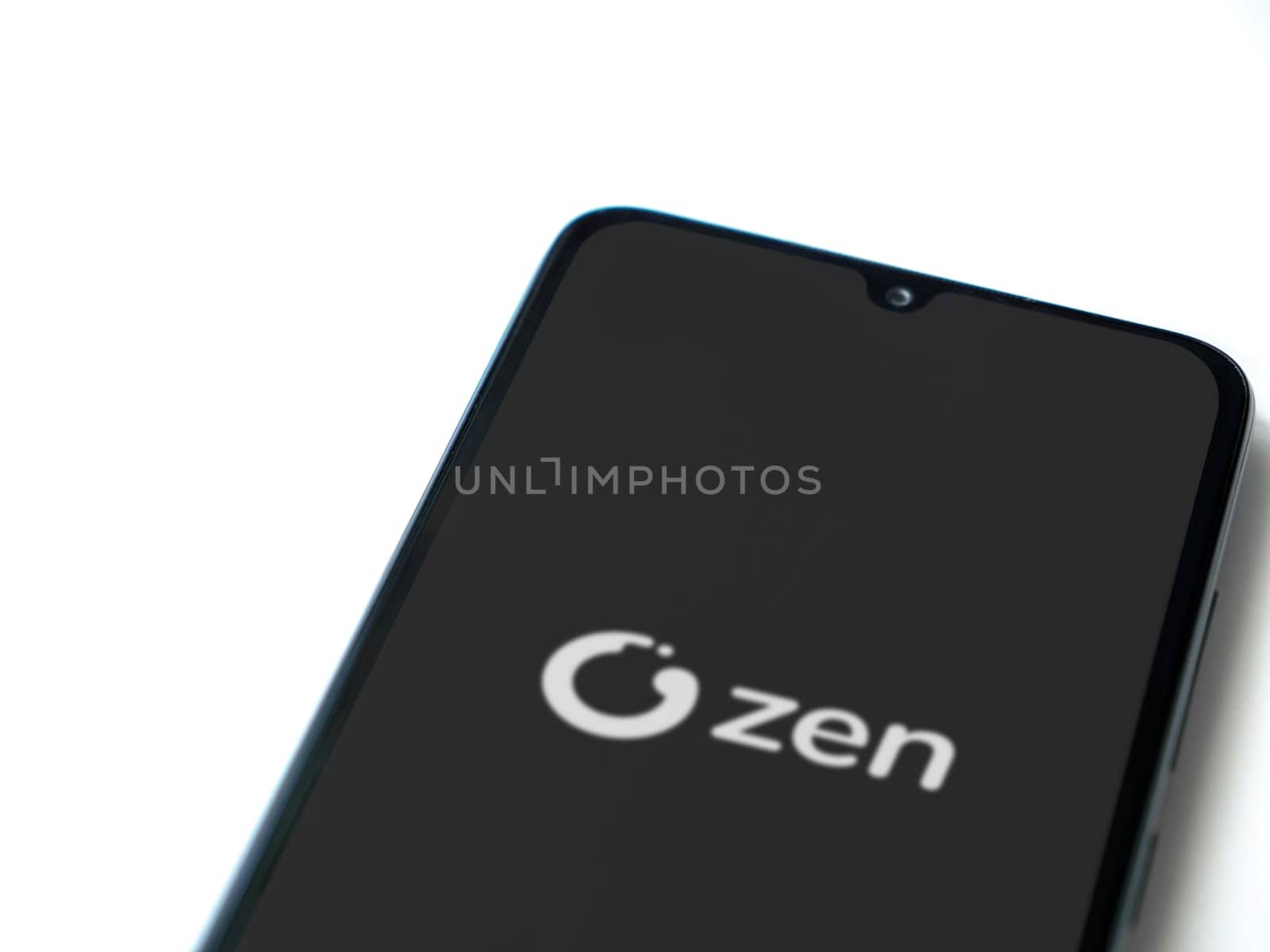 Lod, Israel - July 16,2023: ZEN.COM app launch screen on smartphone on white background. Top view flat lay with copy space.