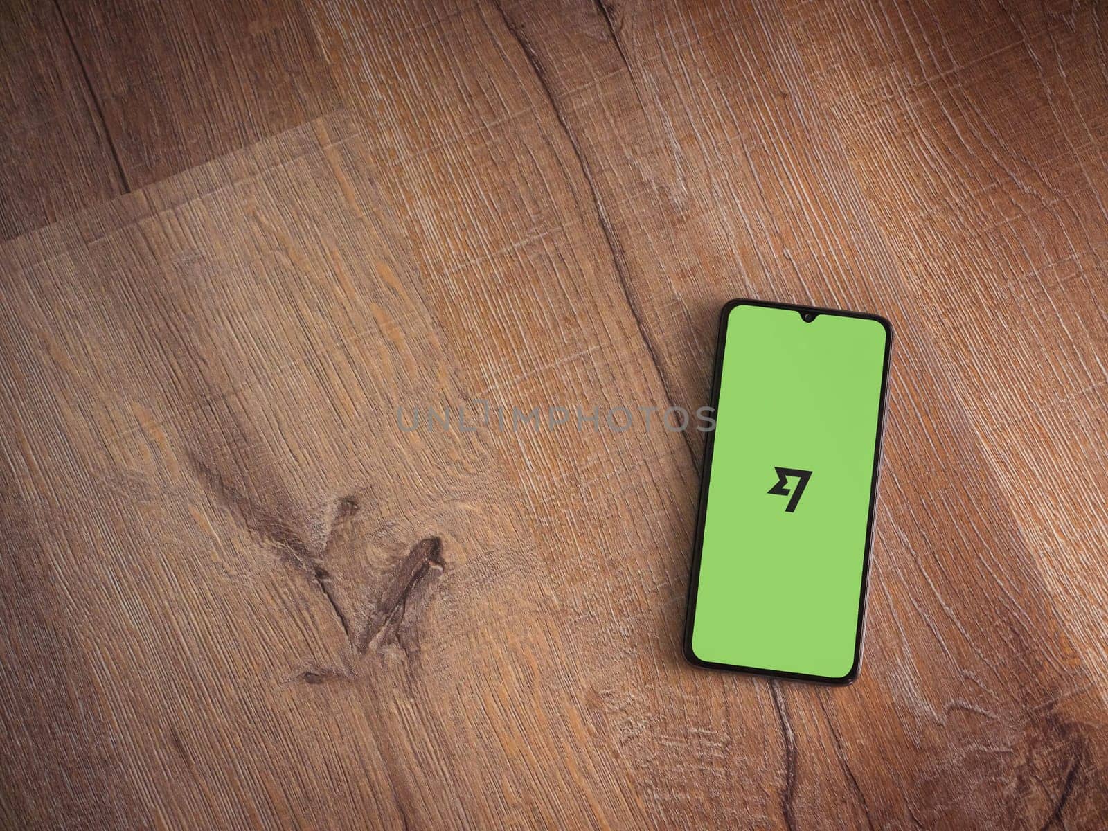 Lod, Israel - July 16,2023: Wise app launch screen on smartphone on wooden background. Top view flat lay with copy space.