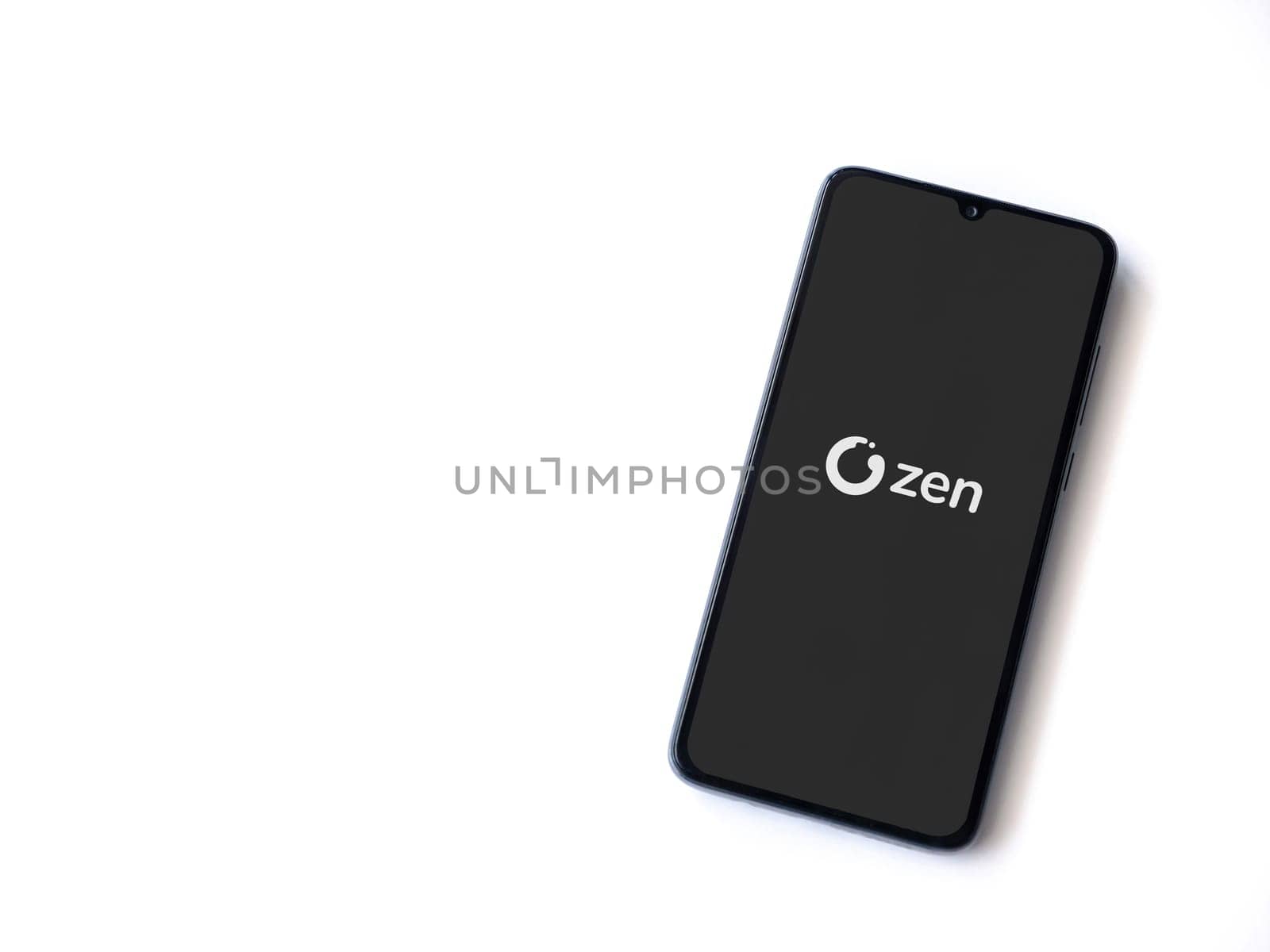 Lod, Israel - July 16,2023: ZEN.COM app launch screen on smartphone on white background. Top view flat lay with copy space.