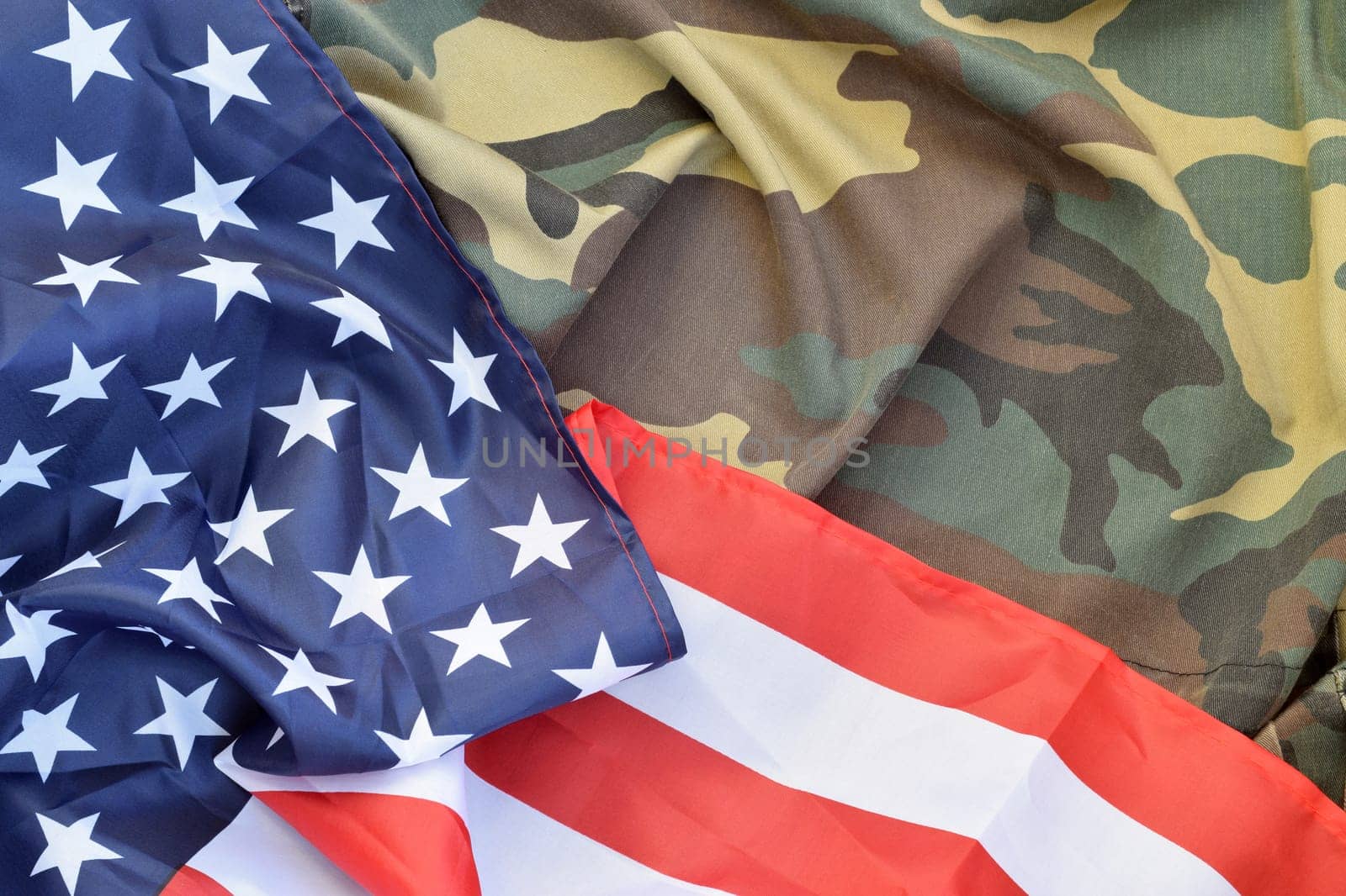 United States of America flag and folded military uniform jacket. Military symbols conceptual background banner for american patriotic holidays design