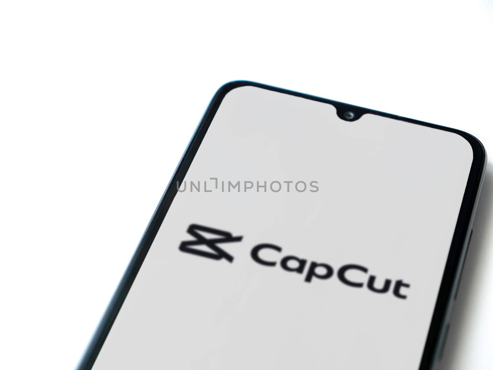Lod, Israel - July 16,2023: CapCut app launch screen on smartphone on white background.. Top view flat lay with copy space.