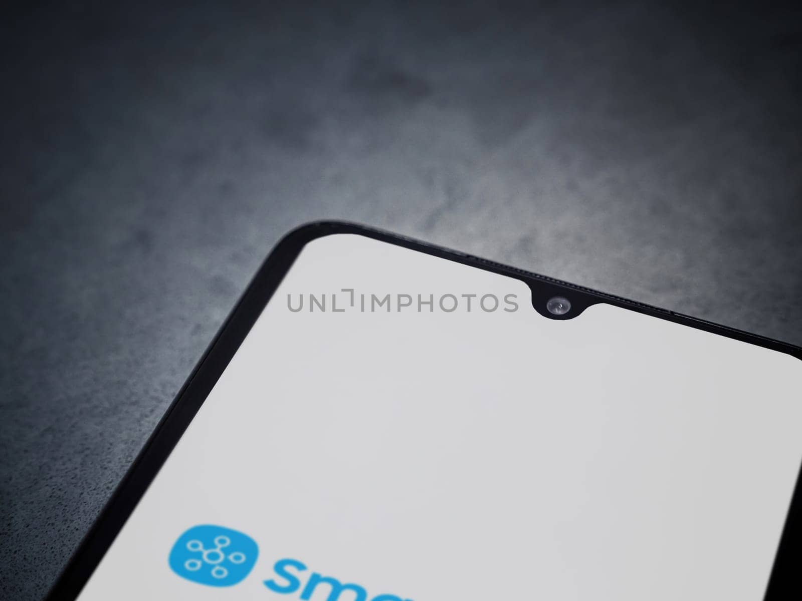 Lod, Israel - July 16,2023: Smartthings app launch screen on smartphone on dark marble stone background. Top view flat lay with copy space.
