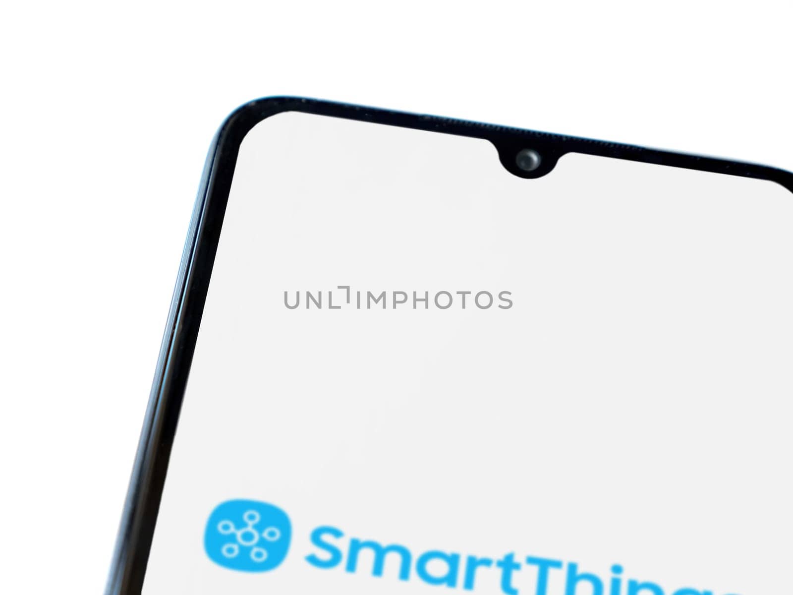 Lod, Israel - July 16,2023: Smartthings app launch screen on smartphone on white background. Top view flat lay with copy space.