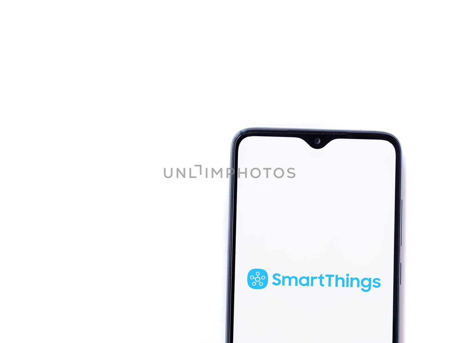Lod, Israel - July 16,2023: Smartthings app launch screen on smartphone on white background. Top view flat lay with copy space.