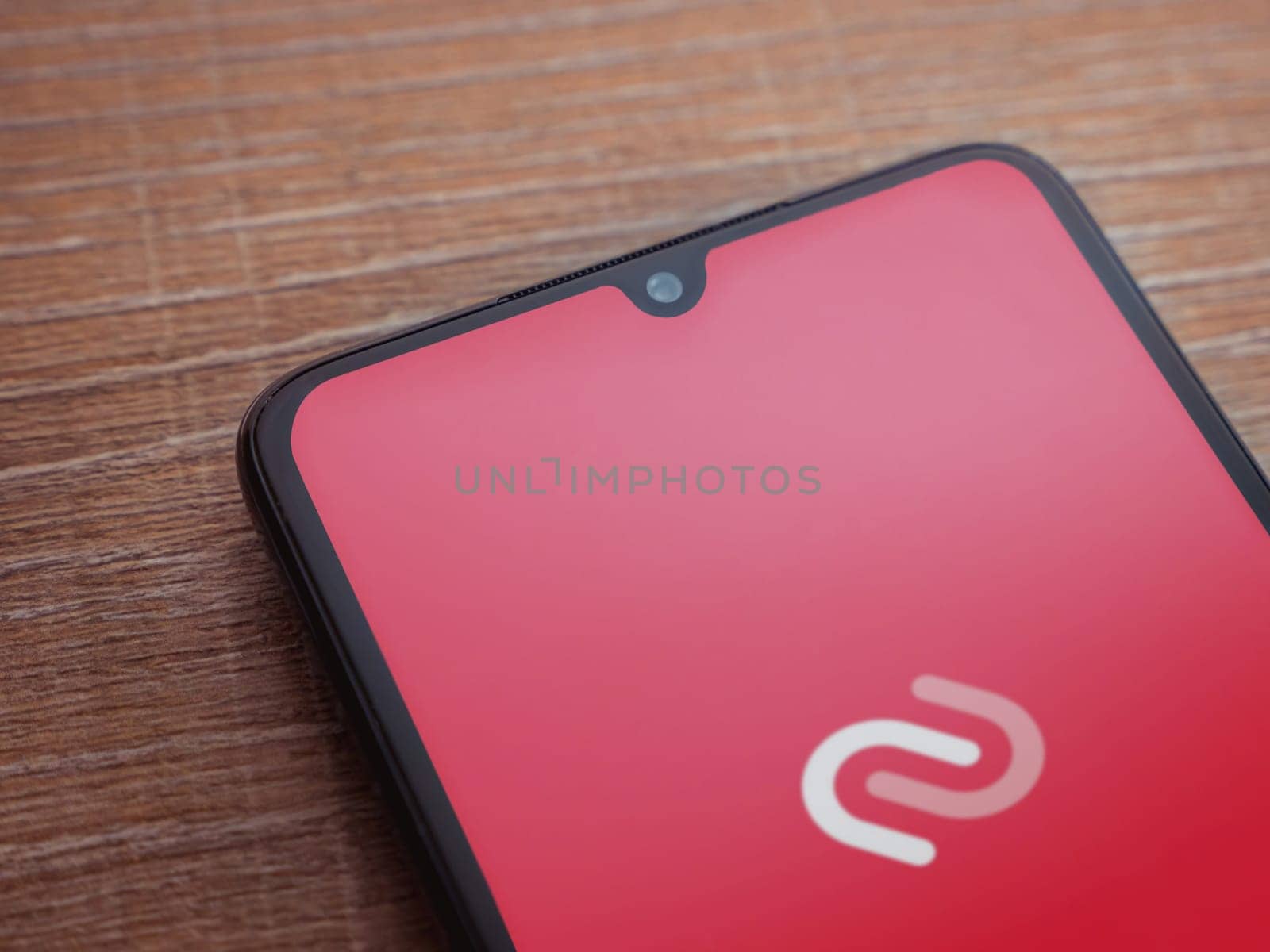 Lod, Israel - July 16,2023: Twilio Authy Authenticator app launch screen on smartphone on wooden background. Top view flat lay with copy space.