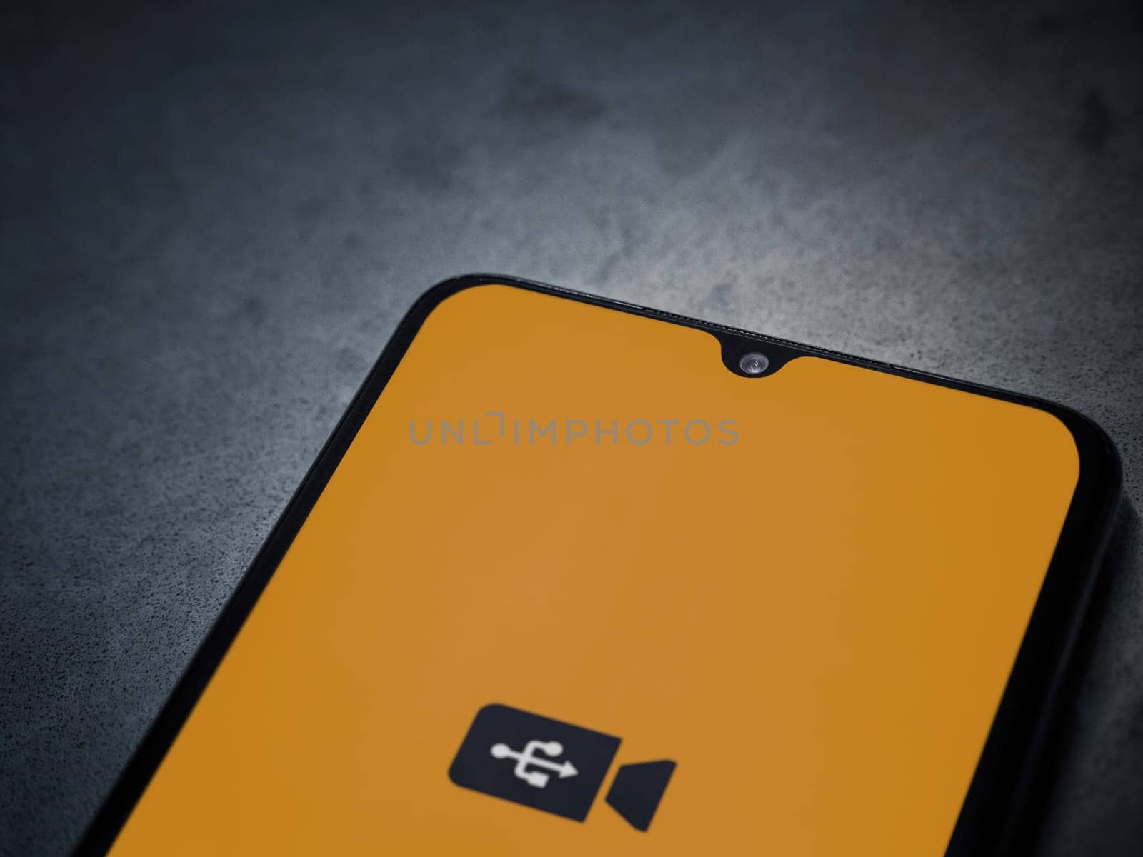 Lod, Israel - July 16,2023: USB Camera app launch screen on smartphone on dark marble stone background. Top view flat lay with copy space.