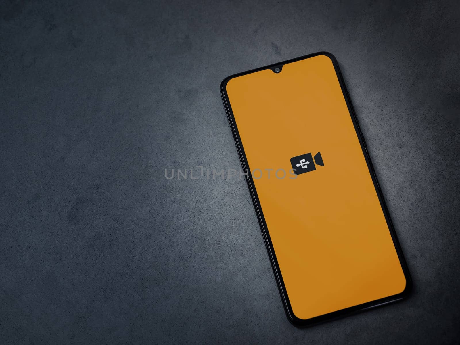 Lod, Israel - July 16,2023: USB Camera app launch screen on smartphone on dark marble stone background. Top view flat lay with copy space.
