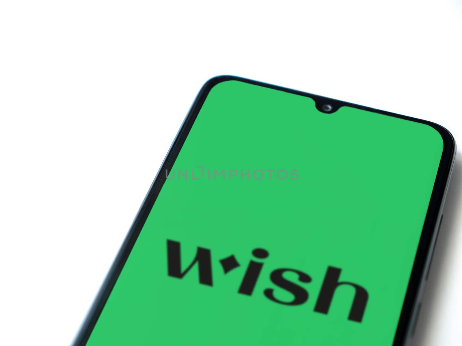 Lod, Israel - July 16,2023: Wish app launch screen on smartphone on white background. Top view flat lay with copy space.