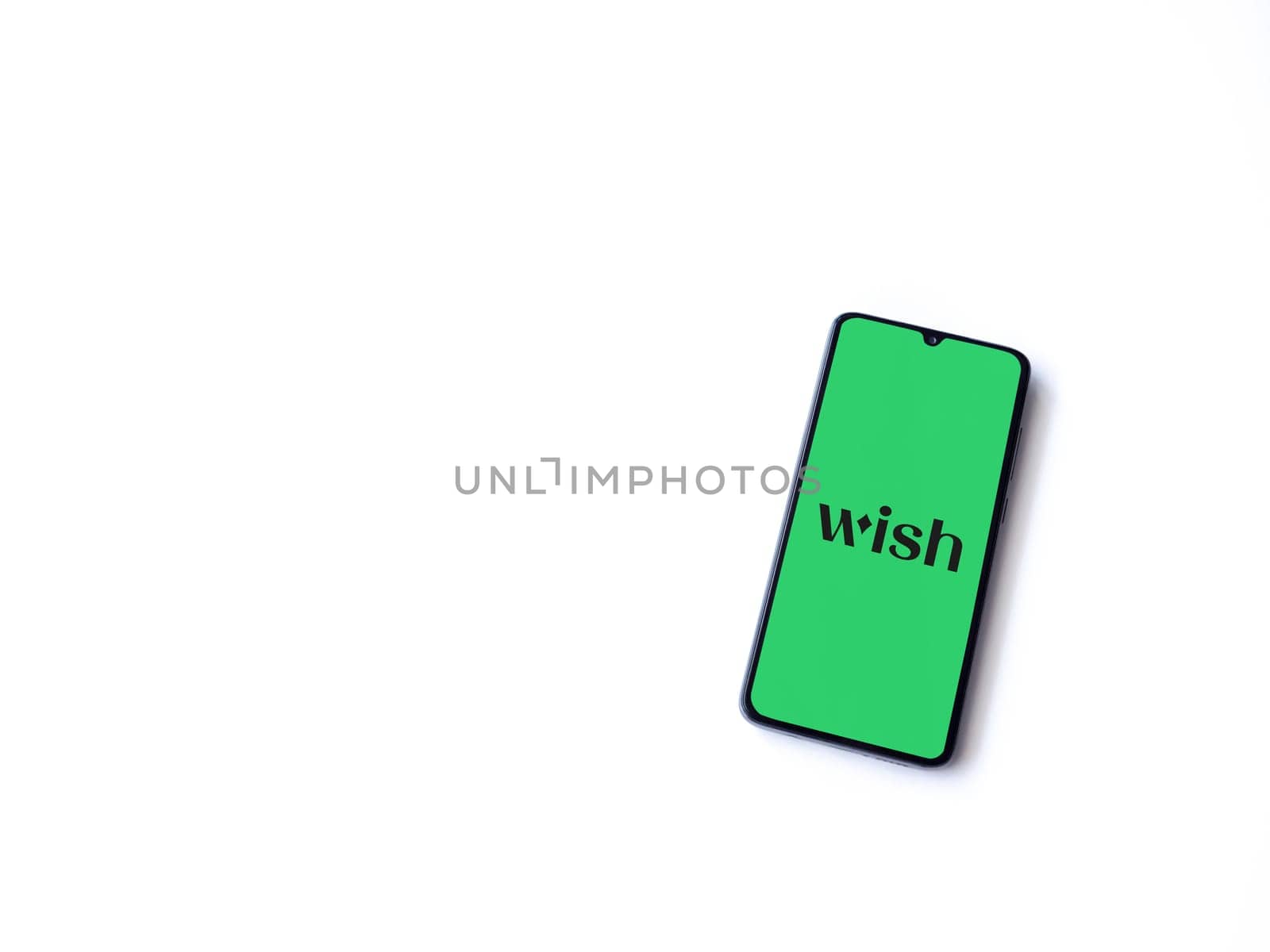 Lod, Israel - July 16,2023: Wish app launch screen on smartphone on white background. Top view flat lay with copy space.
