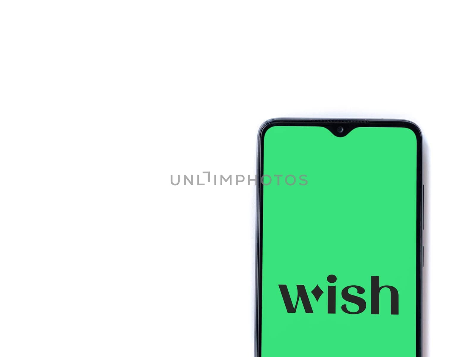 Lod, Israel - July 16,2023: Wish app launch screen on smartphone on white background. Top view flat lay with copy space.