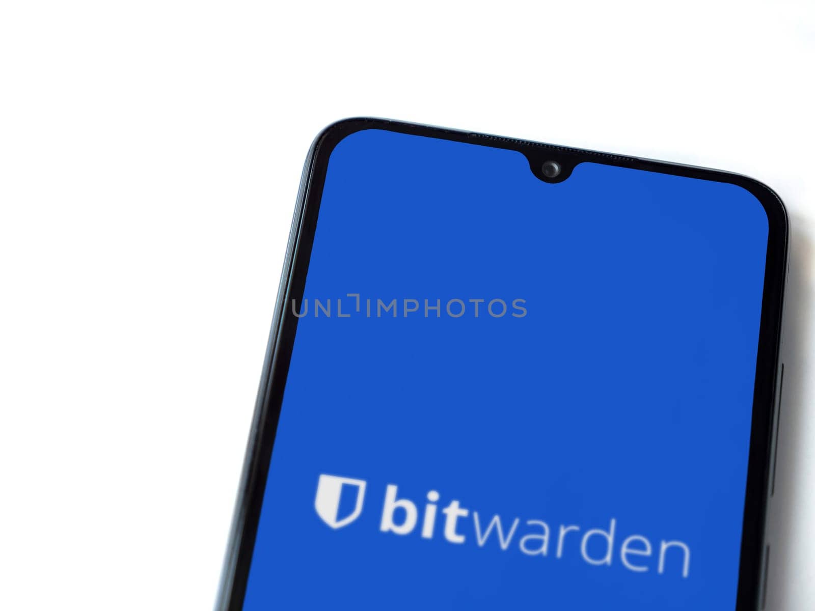 Lod, Israel - July 16,2023: Bitwarden Password Manager app launch screen on smartphone on white background. Top view flat lay with copy space.