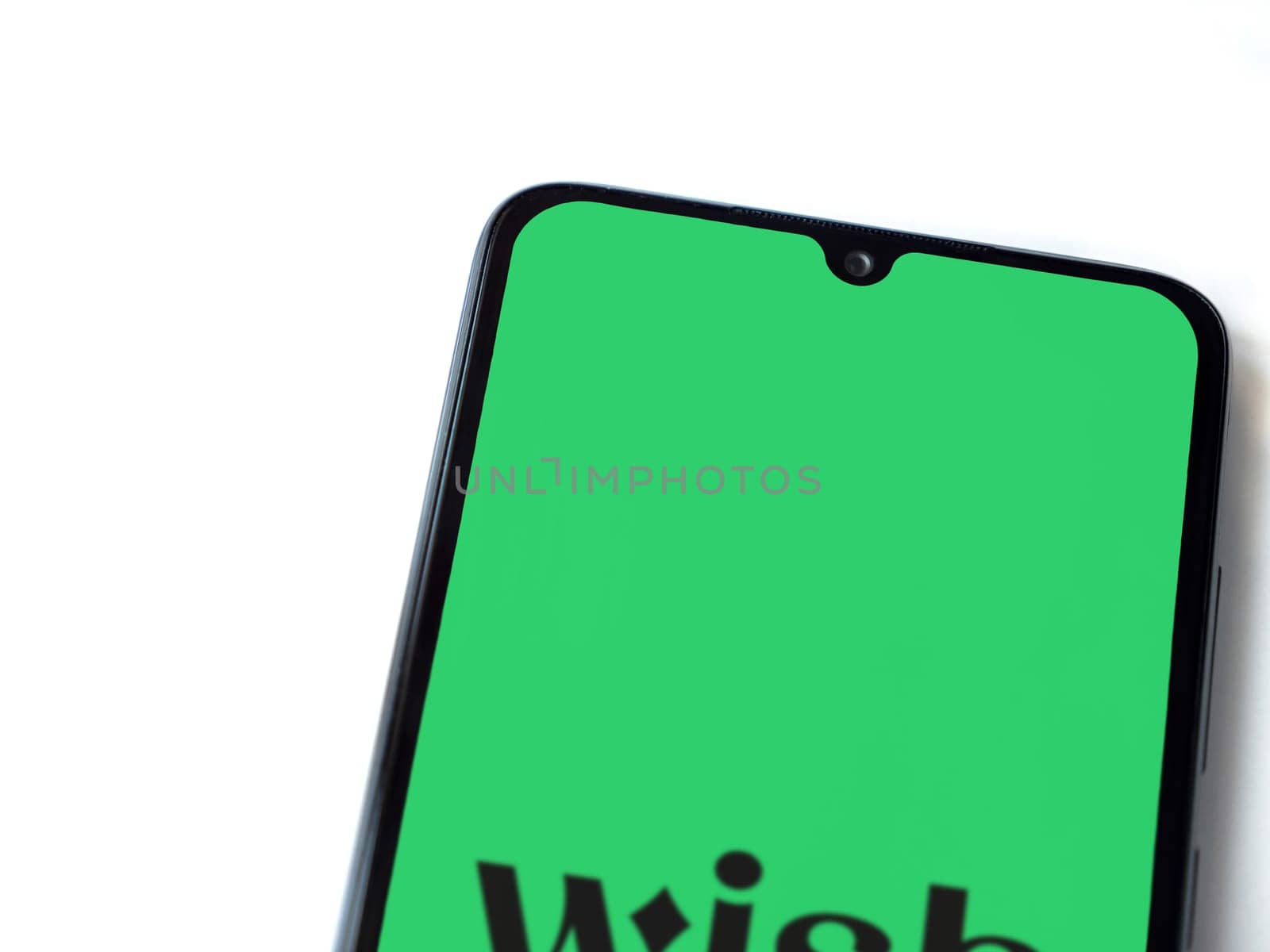 Lod, Israel - July 16,2023: Wish app launch screen on smartphone on white background. Top view flat lay with copy space.