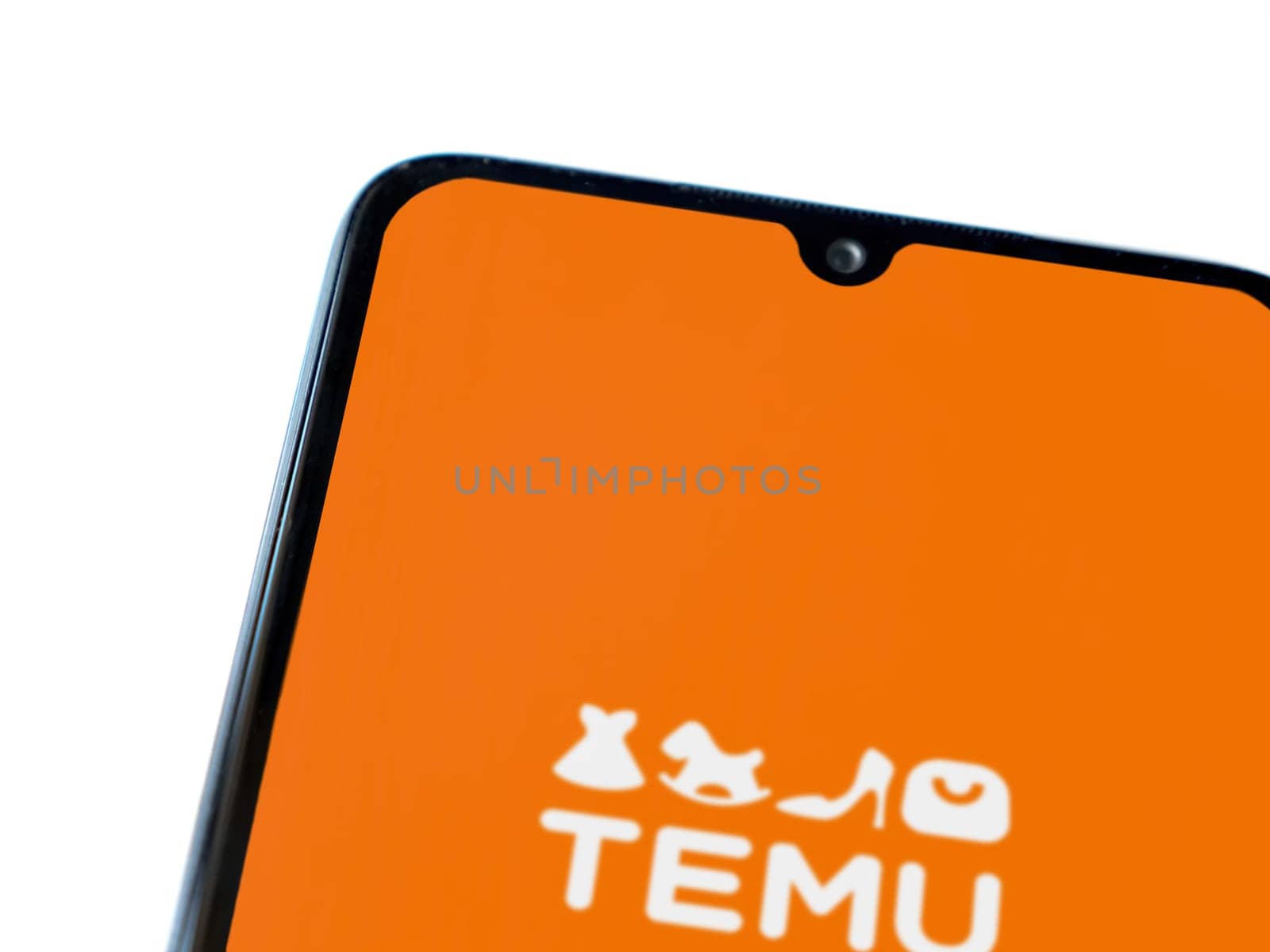 Lod, Israel - July 16,2023: Temu app launch screen on smartphone on white background. Top view flat lay with copy space.