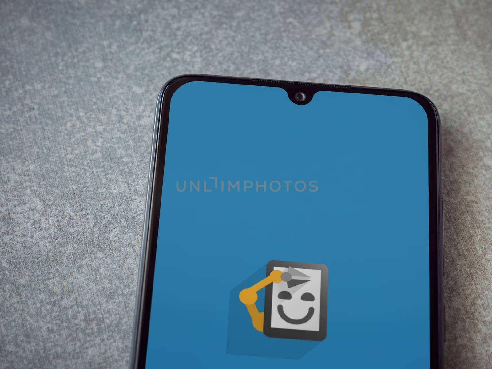 Lod, Israel - July 16,2023: Automate app launch screen on smartphone on ceramic stone background. Top view flat lay with copy space.