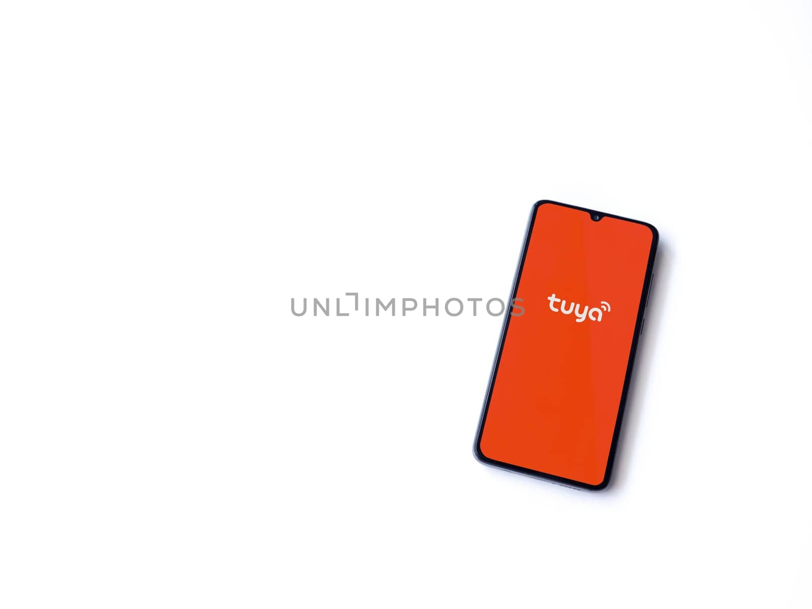 Lod, Israel - July 16,2023: Tuya Smart app launch screen on smartphone on white background. Top view flat lay with copy space.