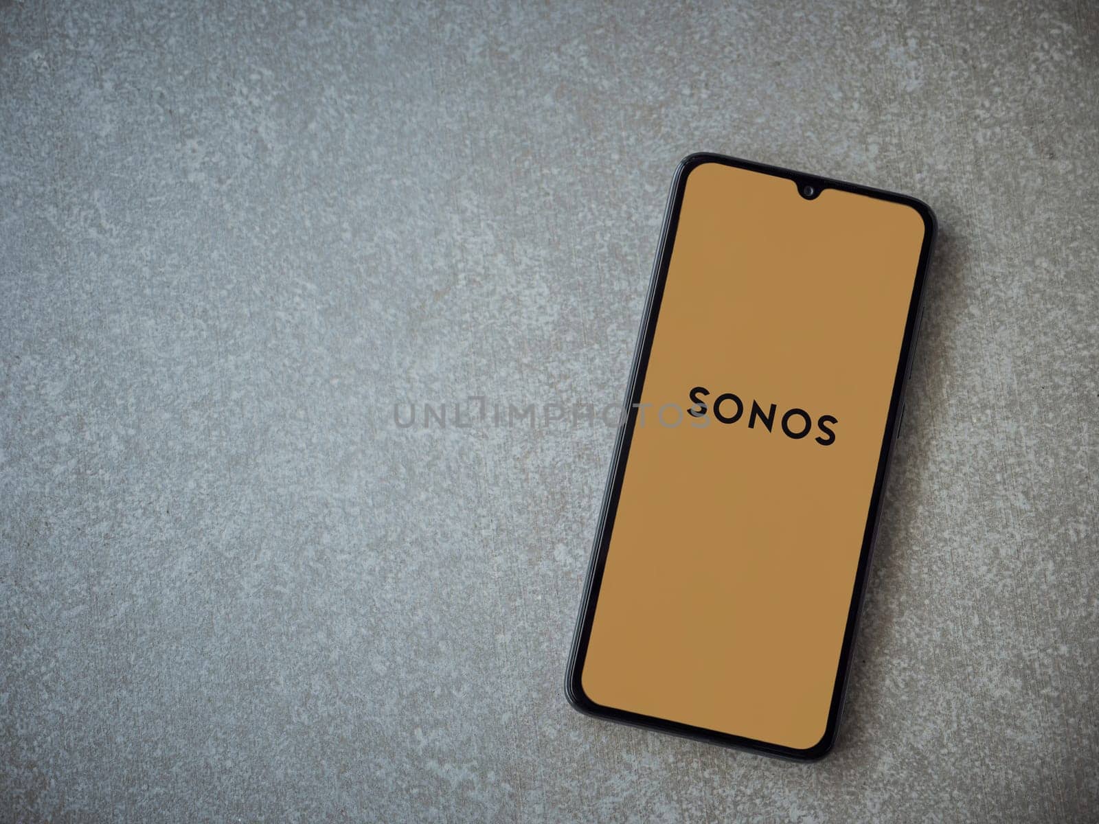 Lod, Israel - July 16,2023: Sonos app launch screen on smartphone on ceramic stone background. Top view flat lay with copy space.
