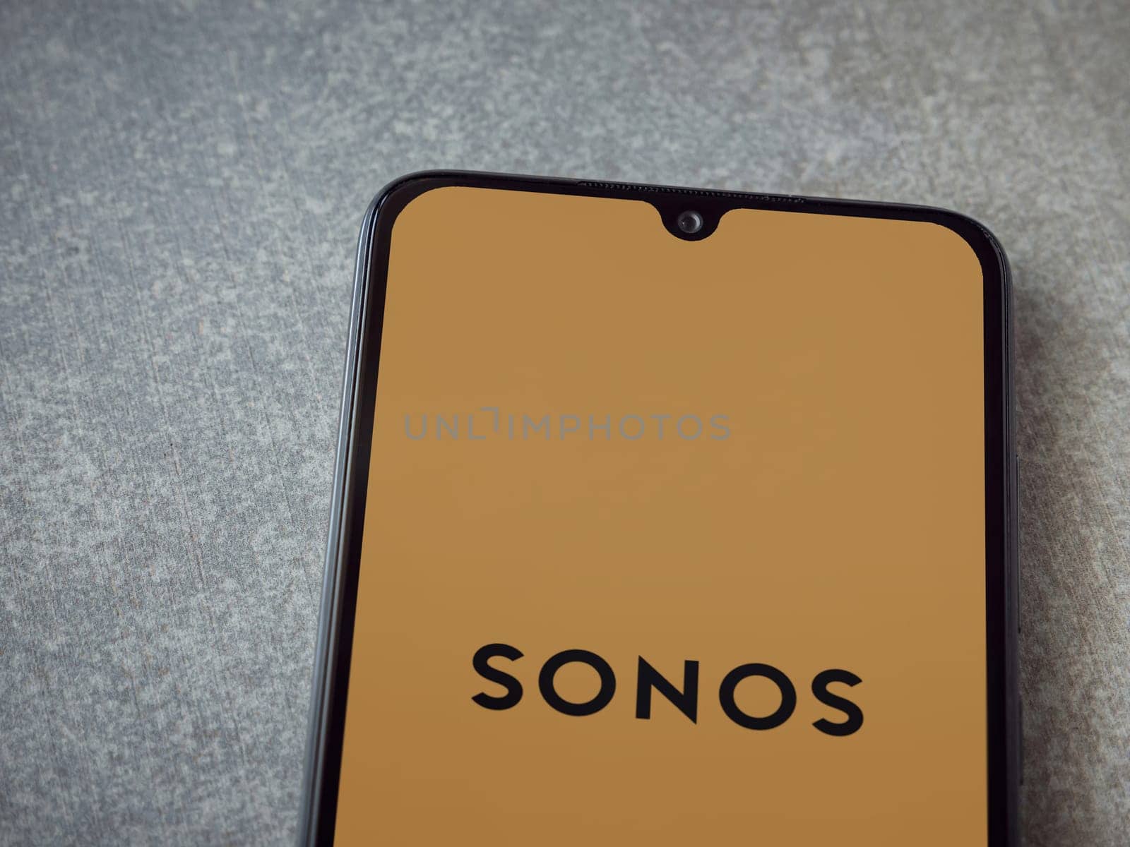 Lod, Israel - July 16,2023: Sonos app launch screen on smartphone on ceramic stone background. Top view flat lay with copy space.