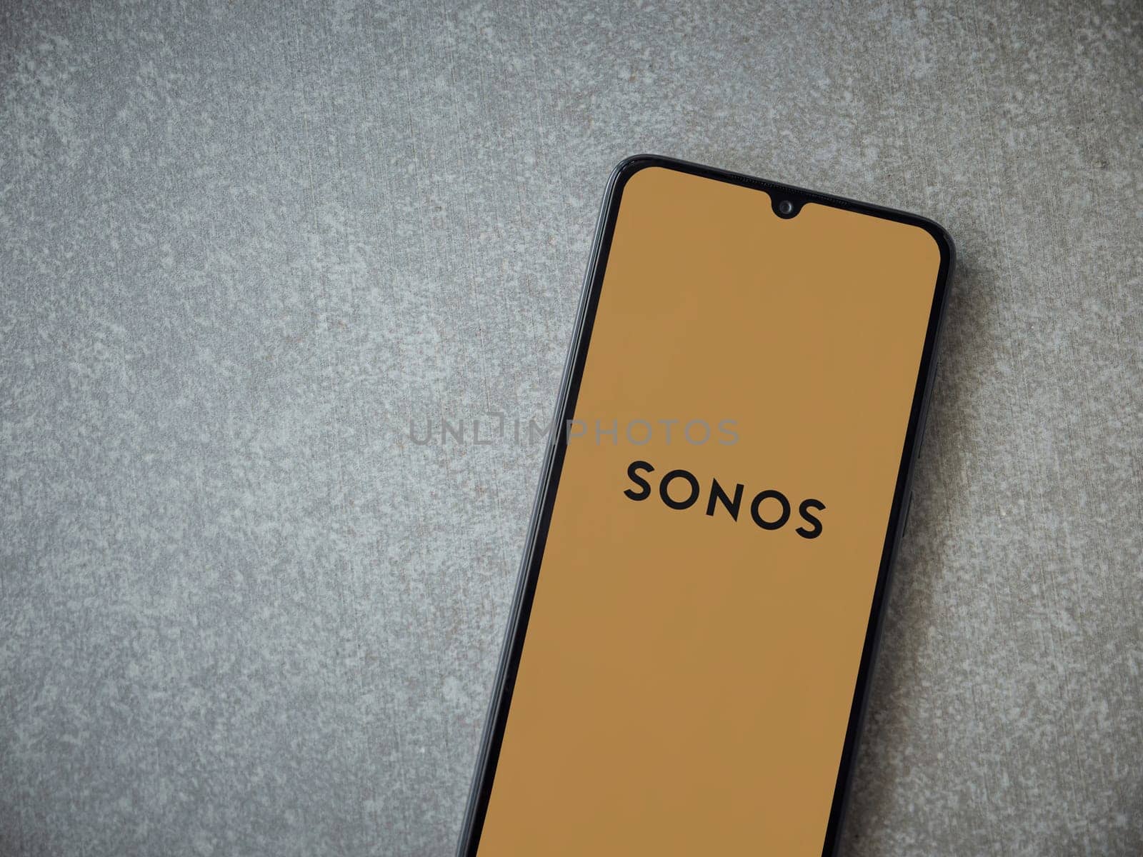 Lod, Israel - July 16,2023: Sonos app launch screen on smartphone on ceramic stone background. Top view flat lay with copy space.