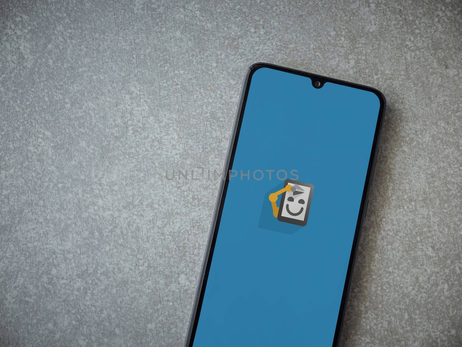 Lod, Israel - July 16,2023: Automate app launch screen on smartphone on ceramic stone background. Top view flat lay with copy space.