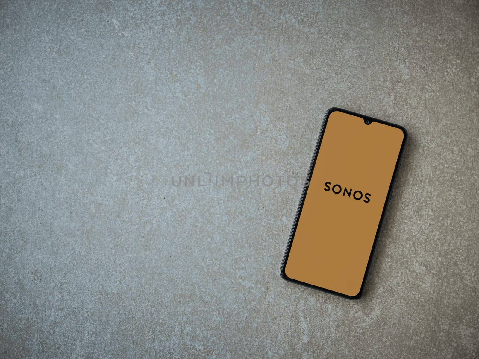 Lod, Israel - July 16,2023: Sonos app launch screen on smartphone on ceramic stone background. Top view flat lay with copy space.