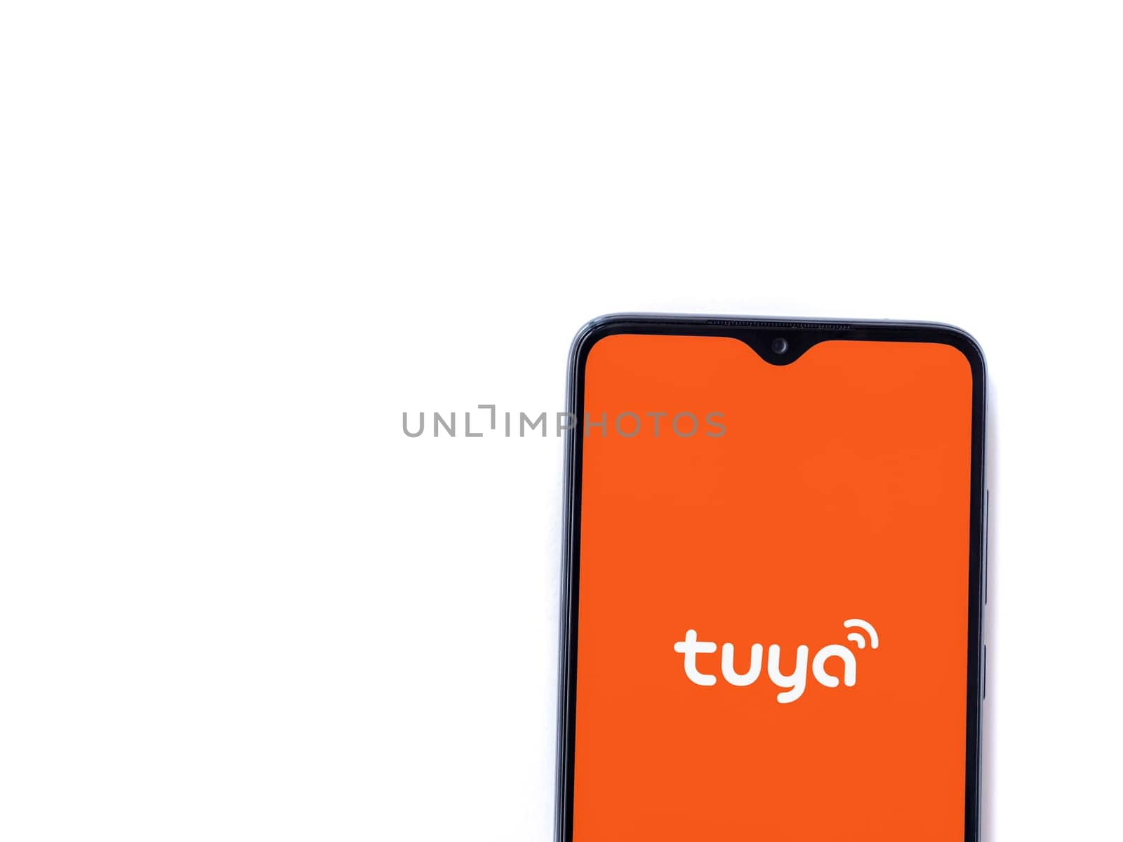Lod, Israel - July 16,2023: Tuya Smart app launch screen on smartphone on white background. Top view flat lay with copy space.