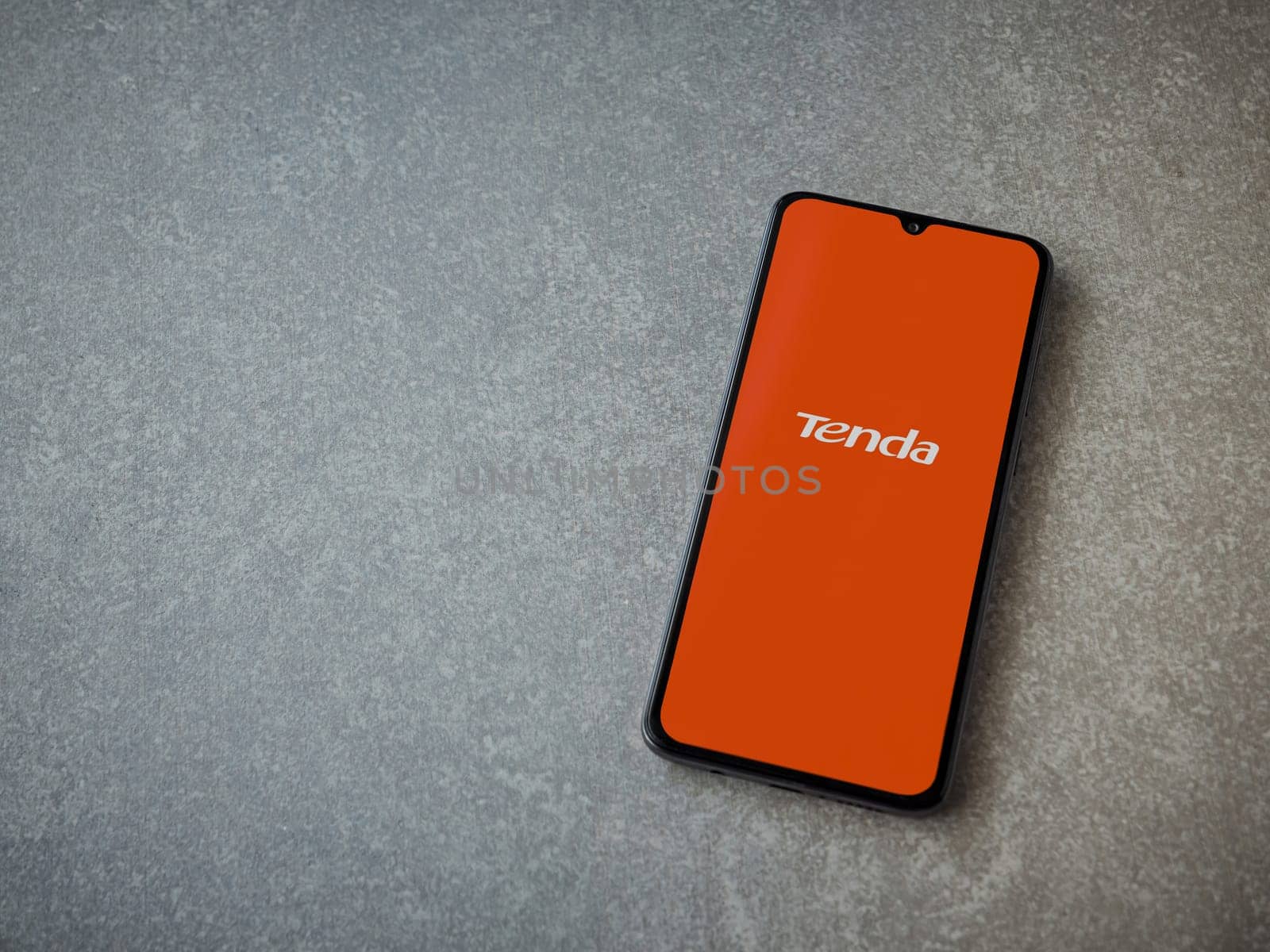 Lod, Israel - July 16,2023: Tenda Wifi app launch screen on smartphone on ceramic stone background. Top view flat lay with copy space.