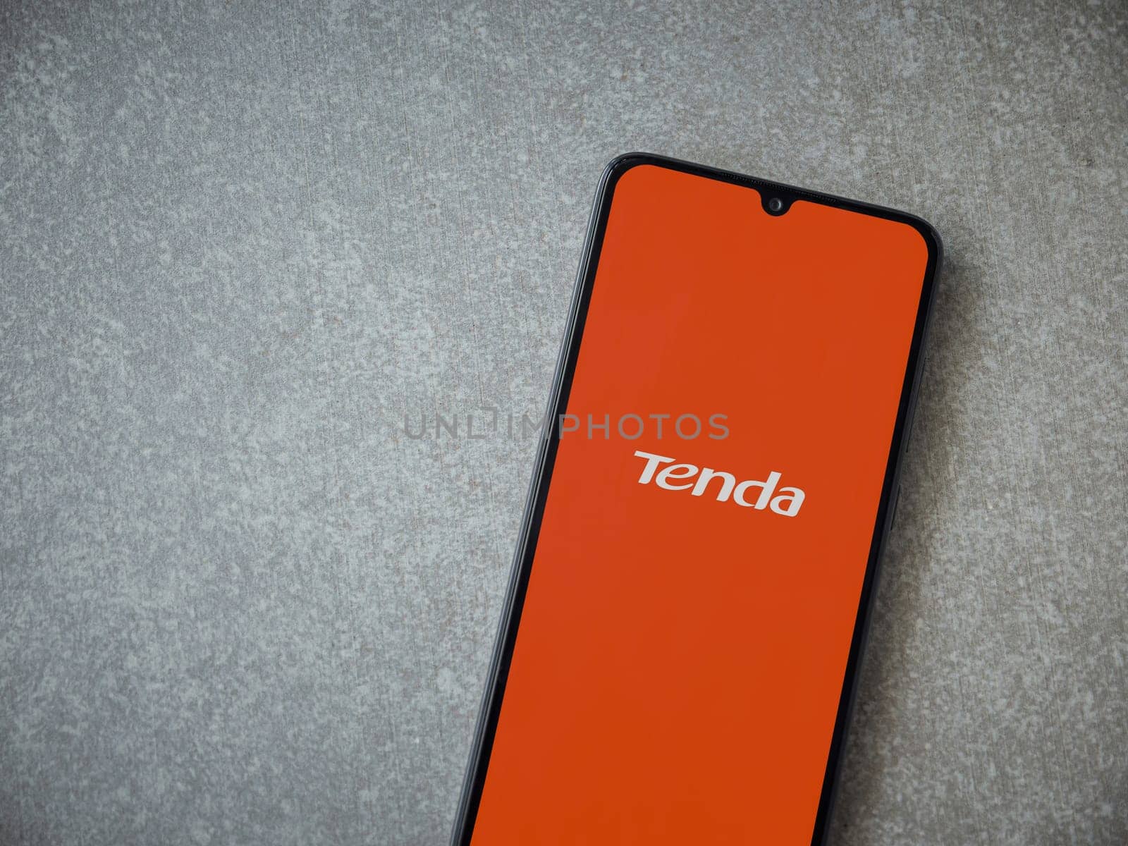 Lod, Israel - July 16,2023: Tenda Wifi app launch screen on smartphone on ceramic stone background. Top view flat lay with copy space.