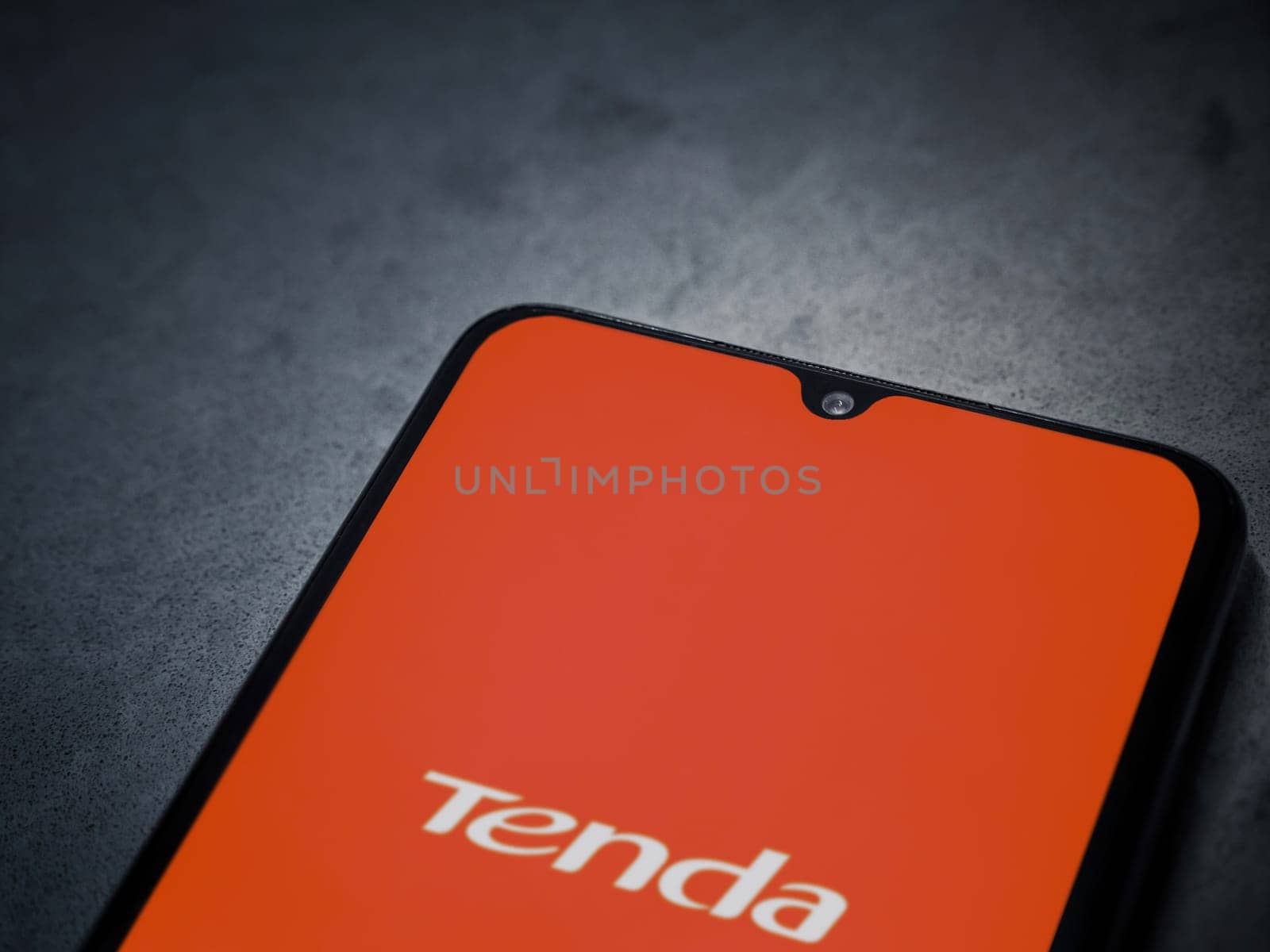 Lod, Israel - July 16,2023: Tenda Wifi app launch screen on smartphone on dark marble stone background. Top view flat lay with copy space.