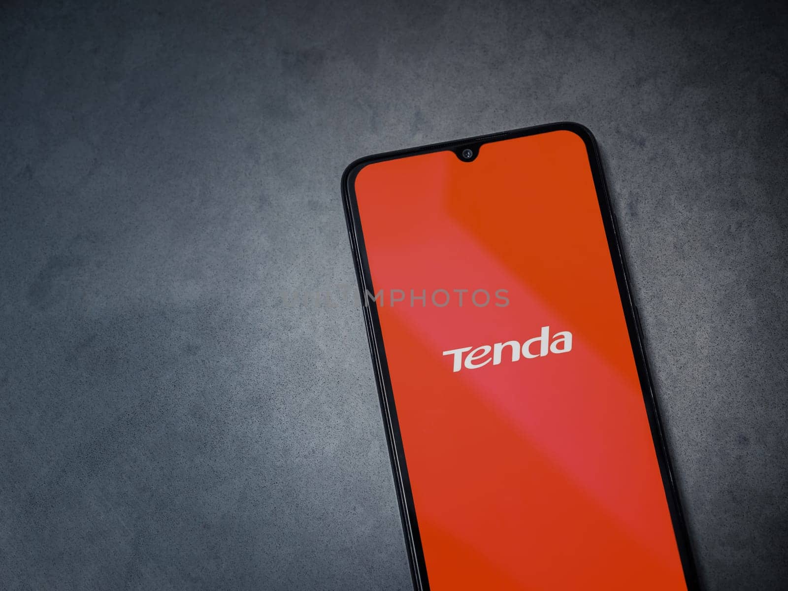 Lod, Israel - July 16,2023: Tenda Wifi app launch screen on smartphone on dark marble stone background. Top view flat lay with copy space.