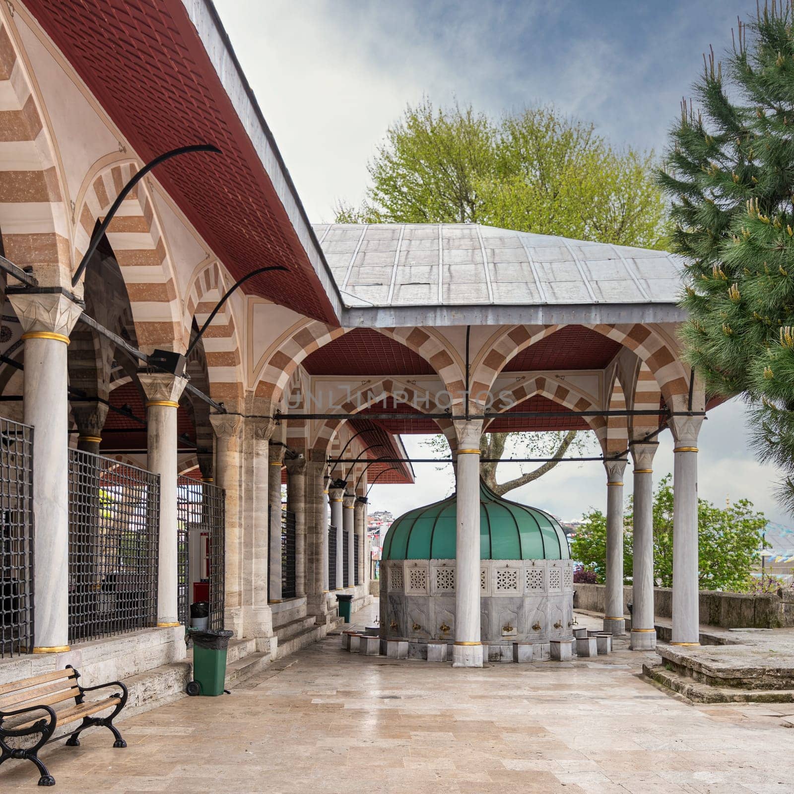 Ablution fountain in the courtyard of the Mihrimah Sultan Mosque in Uskudar, Istanbul, Turkey. The fountain is made of white marble and decorated with intricate carvings